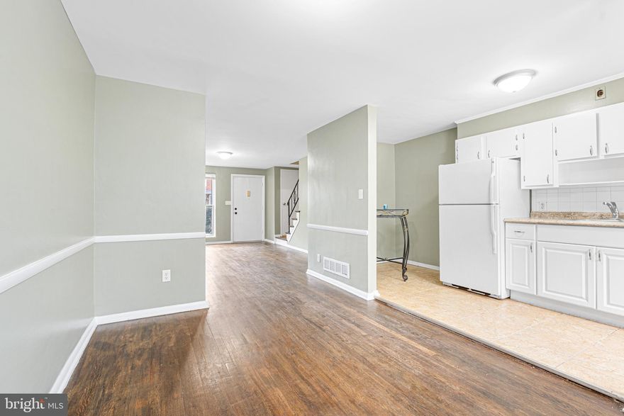 Welcome to comfort and convenience in this charming home nestled on a peaceful, no-thru street—just moments from shopping, dining, and major commuter routes. Enjoy the ease of ample parking with a private parking pad, alley access, and ample street parking. Step onto the covered front porch and enter the living room featuring beautiful hardwood floors that flow throughout the main level. The spacious dining room opens to the kitchen, which offers direct access to the backyard and private parking area—perfect for everyday convenience. Upstairs, you'll find three comfortable bedrooms, a full bath, and access to the attic.  The versatile lower level is ready for your personal touch—ideal for a family room, playroom, or home gym. Plumbing is already in place for a potential second bathroom, and the open layout offers easy access to laundry and utilities. Don't miss the opportunity to make this delightful property your new home!