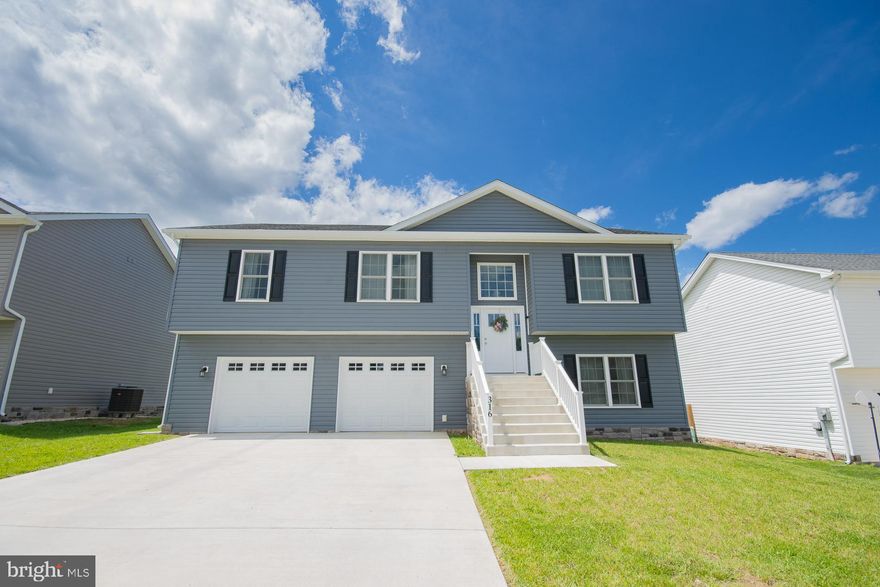 Modern 4-bedroom, 3-bath split foyer built in 2022 in the Red Hill subdivision. The open-concept main level features vaulted ceilings and great natural light. The kitchen includes granite countertops, a center island, and stainless steel appliances. The primary suite offers a walk-in closet and private bath with double vanity. The finished lower level includes a large rec room, fourth bedroom, full bath, and laundry area. Outside, enjoy a spacious backyard with plenty of room to customize. Two-car garage and convenient location near I-81, shopping, and schools.