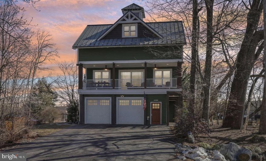 Architecturally distinctive and thoughtfully designed, this three-level contemporary residence offers 4 bedrooms, 2 full baths, and 2 half baths, all set on a corner lot in the established South Haven community. The home combines a flexible floor plan with curated custom details and multiple living spaces that adapt effortlessly to modern lifestyles. The entry level features a versatile bonus room that currently serves as a stylish home bar, complete with built-in elements and a nearby half bath. This space could easily transition into a private office, studio, fitness area, or guest suite depending on the next owner’s needs. The main living level is open and light-filled, anchored by a spacious kitchen with an oversized island, professional-grade gas cooking, and distinctive custom finishes. The kitchen flows seamlessly into the dining and living areas, creating an inviting environment for entertaining and everyday living. One standout feature of this home is the built-in dumbwaiter, offering effortless convenience for transporting groceries, firewood, and other essentials between levels. Upstairs, the primary suite offers a peaceful retreat with a private coffee bar, walk-in closet, and spa-inspired bath. Two additional bedrooms, a full hall bath, and an upper-level laundry area complete the sleeping level. A ladder-access rooftop lookout provides a unique bonus space and elevated 365 degree view of the South River / Broad Creek and the Southaven Community. Outdoors, mature landscaping and wooded surroundings offer privacy while maintaining proximity to community amenities. Extensive hardscaping, a detached storage shed, and pre-installed hot tub wiring enhance the backyard’s potential. Located just steps from the neighborhood park with convenient access to major commuter routes, this home delivers design-forward living paired with everyday practicality. Don't miss your chance to make this your new home!