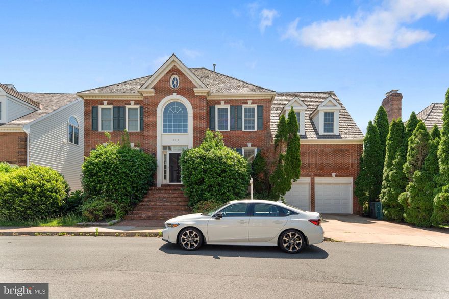 2113 Arrowleaf Drive in Vienna, VA is a beautifully renovated Colonial-style home located in the heart of Tysons Corner. Built in 1994, it features 5 bedrooms, 4.5 bathrooms, and approximately 5,016 square feet of living space on a 0.12-acre lot. The home offers a gourmet kitchen with granite countertops, stainless steel appliances, a tile backsplash, and a butler's pantry. The primary suite includes a sitting room and a luxurious en suite bathroom with a soaking tub and separate shower. The finished lower level provides an additional bedroom, full bath, wet bar, and spacious recreation room. Smart home features, new windows, hardwood floors, LED lighting, and a 2-car garage add to the home's appeal. Located near the new Silver Line Metro, I-495, and close to shopping, dining, and entertainment in Tysons Corner, this property is ideal for convenience and comfort.