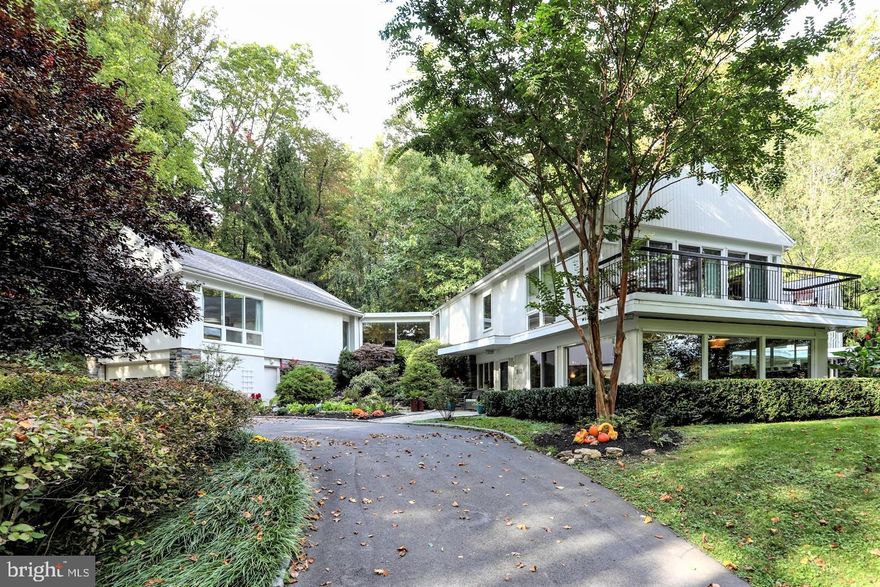 NEW LISTING!   Secluded Elegance, this home is sure to please even the most sophisticated homeowner. Nestled back in the woods down a long private lane this custom crafted contemporary home is perfectly situated on a premium 2+ acre lot. As you approach the home the circular driveway greets you with a dramatic courtyard entrance presenting a multi-level lighted water feature and fish pond. The residence has been carefully positioned with precise attention to detail offering spectacular views of the lush landscape from every window. Throughout the home you will appreciate the natural ledgestone walls, rich finished hardwood flooring, and large window walls that fill the rooms with sunlight and vibrant color. Within 5,100 sf of living area you will find; 5 bedrooms complimented with 4 1/2 well-appointed baths, the formal living room adjoining the open dining room that is fitted with a wood burning fireplace, a vaulted ceiling family room with a floor to ceiling stone fireplace and sliding doors leading to a rear slate patio with a spa tub. Your guests will surely be impressed with the custom kitchen fitted with bamboo cabinetry, granite counters, a glass walled breakfast area and amazing views of the hardscape porch and relaxation area with wooded buffers. The luxurious master suite presents elevated views and includes a private balcony, a gorgeous master bath, as well as multiple large fitted closets.  You will also find a second 24' family room that leads to the spacious junior suite with an open beamed ceiling. Completing the home is a 3 car heated garage and additional parking to accommodate your guests. Privacy, luxury, convenience and Radnor Schools, what more could you ask for? Come see for yourself all this unique home has to offer.  One Year Home Warranty Included.