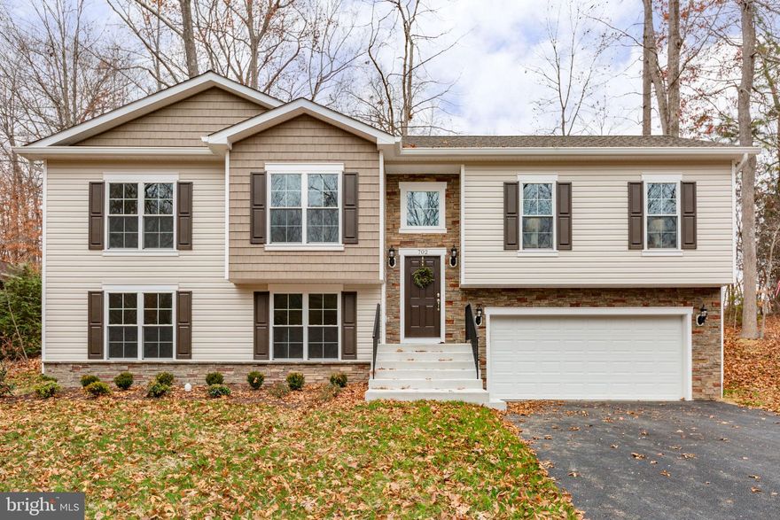 ★ BUILDER WILL PAY ONE YEAR OF HOA DUES ($2295) AND UP TO $10,000 IN CLOSING COSTS! ★ OVER $90,000 OFF THE ORIGINAL PRICE, THIS HOUSE IS PRICED TO SELL!!!!!    Discover the perfect blend of modern living and community charm in this stunning new construction home located in the desirable Lake of the Woods subdivision. Completed in 2025, this split foyer residence boasts 3 spacious bedrooms and 3 luxurious bathrooms, designed with an open floor plan that invites natural light and warmth throughout. Step inside to find exquisite interior features, including granite countertops, a stylish kitchen island, and stainless steel appliances that make cooking a delight. The family room seamlessly connects to the dining area, creating an ideal space for gatherings. Enjoy the convenience of a walk-in closet in the primary suite and a cozy breakfast nook that overlooks the serene backyard, which backs to lush trees for added privacy. The exterior is equally impressive, featuring durable vinyl siding and stone accents, along with a welcoming porch and expansive deck perfect for outdoor entertaining. With an attached garage and ample driveway space, parking is a breeze. As part of the Lake of the Woods community, residents enjoy a wealth of amenities, including a clubhouse, swimming pool, tennis courts, and scenic picnic areas. The community also offers access to beautiful parks and recreational facilities, ensuring a vibrant lifestyle for all. Located near top-rated schools and essential public services, this home is not just a place to live, but a gateway to a fulfilling lifestyle. Embrace the opportunity to make this exceptional property your own and experience the best of community living!