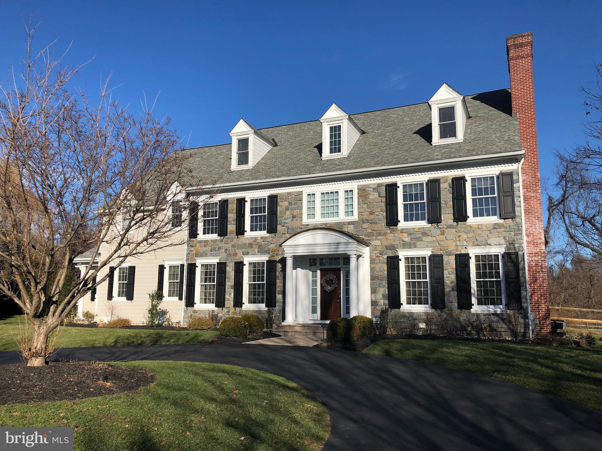 REMARKS: This elegant custom home was built by B.J. Drueding Builders, one of the Philadelphia Main Line's most respected builders. The architectural design was by the Ann Capron Group, also one of the most well regarded design firms in the area. This custom home, reminiscent of the classic Philadelphia Main Line home, with a circular drive, has been professionally landscaped. It is situated on a very private 1.3 acre flat lot backing to Chester County Conservancy lands and offers Eastern exposure in the back. The outstanding features of this executive residence include a gracious and welcoming 2-story Foyer with a turned staircase, a gallery hallway, and rich wide plank mahogany hardwood flooring throughout most of the first floor. The first floor features formal Living and Dining Rooms, a Butler's Pantry, both Formal and Family Powder Rooms, a great Family Room, an Office/Study, Gourmet Kitchen, Mud Room and more. The Gourmet Kitchen and Morning Room, have Travertine tumbled marble tile floors, a full wall of windows overlooking the private spacious back yard, and opens to the Family Room with a gas fireplace. A door from the Morning Room leads to the custom built paver Patio with a wood burning built-in pizza oven, granite counters, additional wood burning outdoor fireplace and abundant space to entertain or relax. The turned hardwood staircase leads to the second floor and the double door entrance of the Master Suite with mahogany hardwood floors, tray ceiling, chandelier, and custom walk-in closet featuring a magnificent wardrobe island with built-in clothes drawers and shelving. The Master bathroom offers a luxurious whirlpool tub, marble shower, his and her vanities and a private water closet. Continue down the hallway with hardwood floors to 3 additional bedrooms; one with full bath en suite and 2 that share Jack-n-Jill full bath en suite, and a spacious laundry room. A carpeted staircase leads to the finished third floor, offering flexible use options: 5th bedroom, in-law or nanny suite, recreation area, media room or in-home gym, complete with a full bathroom en suite and additional sitting room. Minden is an award winning community of 10 high-end custom homes that was conceived by B.J. Drueding Builders. The location is suburb, bordering the George Lorimer Nature Preserve to the South, the Chester County Conservancy to the East and Valley Forge Mountain to the North. The views in all directions from this home are breathtaking.