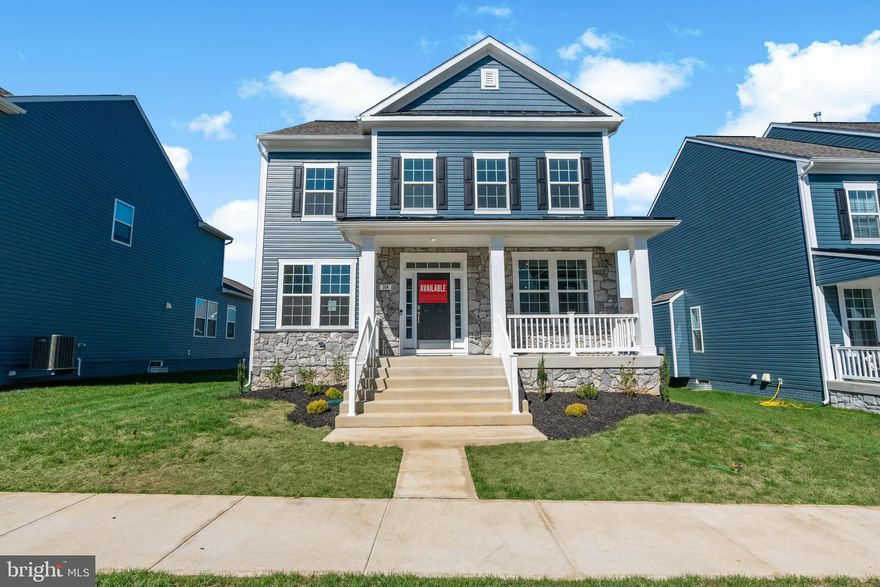 The only community within historic Charles Town with resort style amenities!
**UP TO $20,000 CLOSING COST ASSISTANCE AVAILABLE ON SELECT HOMES, FOR PRIMARY RESIDENCE WITH USE OF APPROVED LENDER AND TITLE!**
Looking for a home close to historic Charles Town in an amenity rich established community? Meet the Clemson, with its grand 22 ft wide front porch with lights,  black metal roof, impressive pillars, partial stone front, and transom window over front door you will find yourself daydreaming of decorating this space for the holidays. Inside you are greeted with 9ft. ceiling with crown molding and tall 6ft. windows on the first floor that allow natural light to fill this open floorplan.  In addition to the crown molding the formal dining room and private study have chair rail molding. The private study offers French door entry with glass inset panels.  The entire main level features easy to clean durable luxury vinyl plank flooring.  Powder room is nicely located between foyer and family room. Walking back to the open family room and kitchen you will see a gas fireplace with mantel featuring an HDMI prewire allowing you to enjoy movie night with a cozy fire.  Additional windows in the family room offer a bright open feel.  The chef in your family will be delighted with the gourmet kitchen offering 5 burner gas cooktop, gleaming stainless steel externally vented hood, microwave and convection wall ovens, hidden controls upgraded dishwasher with 3rd rack, and a French Door refrigerator with convenient filtered water and ice dispensing. Wide double door pantry with 5 shelves offers room provides space for an organized, well-stocked kitchen.  Warm wood tone full overlay cabinets include 42” upper cabinets with crown molding trim.  The prep island is over 7ft. and features a hidden pull-out trashcan/recycling bin and a single bowl stainless undermount sink with in sink garbage disposal.  Prep island offers 3 modern black matte and ebony wood-stained pendants that accent the black gooseneck pull down faucet and matte black cabinet knobs. The star of this kitchen is the light Italian quartz countertops with striking marbling and delicate mix of warm and cool shadings offering an elevated aesthetic to this designer palate.  White subway tile backsplash is the finishing touch to this luxurious kitchen.  The breakfast nook offers a slider exit to a future deck or patio space that could be added to the home.  Home offers a convenient 2 car parking pad behind the home with a mudroom entryway with large closet for coats and shoes and plenty of room to add a drop zone area for backpacks or sports gear.  Climb the hardwood stairs to the bedroom level to find a well-appointed primary suite with impressive tray ceiling, massive walk-in closet. Primary bath offers dual sink comfort-height quartz vanity with undermount sinks and ceramic tile walk in shower with frameless glass door and glass corner offer quiet luxury.  A bonus is a linen closet in the primary bath to keep your bathroom clutter free and organized. Secondary bedrooms offer generous walk-in closets and feature ceiling light fixture. Both bedrooms have access to buddy bath with ceramic tub/shower and offer 2 sink comfort height vanity.  Laundry is conveniently located on bedroom level and front load washer-dryer is included in this home. Enjoy a finished basement with full bathroom and a walkup stair exit to the back yard.  This home meets today’s stringent energy code offering 2 x 6 construction with R-21 exterior wall insulation, low profile bright energy efficient LED lighting in the kitchen, family room, foyer, hallways, and basement. Ceiling fan pre-wires are included in all bedrooms and family room.  All windows and exterior doors are insulated, and windows feature tilt in lower sills for easy cleaning.  Tankless gas hot water heater will also save you money.  Enjoy a fully sodded yard with included front landscaping package.