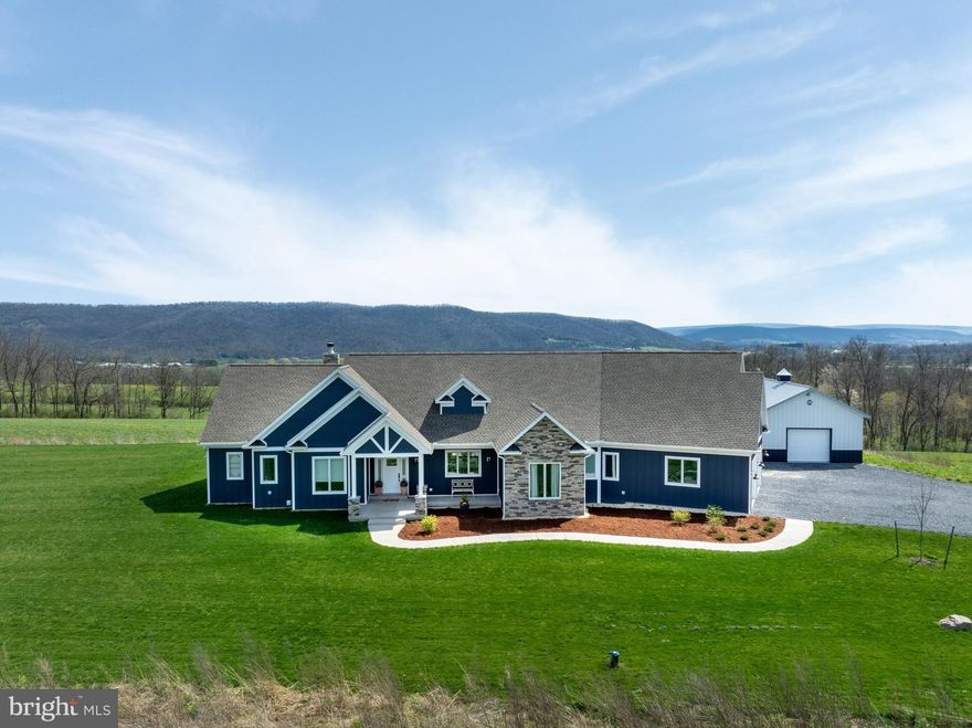A true oasis within Century Estates is found on Big Hill Lane! This custom-built ranch, completed in 2022, is perfectly positioned on 17.76 serene acres offering stunning views of Penns Valley. Built by Sven Wetzel, quality craftsmanship is abundant throughout this beautiful home starting at the welcoming covered front porch down to the auto touch custom blinds in the dining room. You’ll appreciate the open concept floor plan upon entry, 7-inch CoreTec engineered hardwood floors throughout the home and the abundance of natural lighting from the windows providing unobscured views from everywhere in the house! At the heart of the home is the open concept great room featuring a floor-to-ceiling stone fireplace flanked by custom built ins and a cathedral ceiling adorned with reclaimed barn timbers. Fall in love with the gourmet kitchen featuring a spacious oversized island with storage on either side and stainless-steel appliances including a Wolf range with convection oven and griddle! The owner’s suite boasts a spa-like private bathroom with access to the oversized closet, walk (or roll) in stone and tile shower, a soaking tub as well as dual vanity with gorgeous fixtures and custom hardware. This owner’s suite also features fogged French doors leading to the back patio for pool access! The home features 2 additional bedrooms and another well-appointed full bath as well as loft area for designated home office or additional living space. The attached finished and insulated garage accommodates 2 cars, plus a side bay for riding mower or recreational vehicle. Enjoy this summer poolside! The heated pool designed and constructed by Gary Thull Pool in 2022 features automatic and locking pool cover as well as underwater decorative in-pool lighting for night swimming! The 40x24 Morton barn features lots of storage space and would be ideal for the hobbyist. The extensive pasture land is ideal for horse or farm animals. Bonus features of the home include attic access off the loft which has lots of potential for additional square footage and lots of storage space. Don’t miss the features sheets with descriptions of the many features of the home and the extensive list of included items (snow blower, tiller, lawn mower, patio furniture and more!). Most of the furnishings and décor are also negotiable.