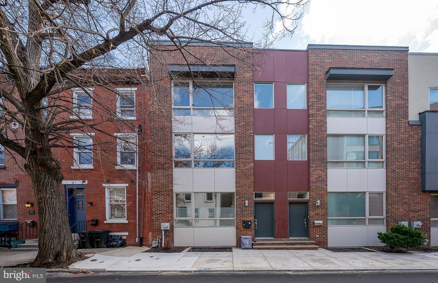 Located in the vibrant Northern Liberties neighborhood, this exceptional townhome offers modern living at its finest!  With a spacious open floor plan, this townhome is perfect for both entertaining and everyday living. Step into the inviting entry featuring a bedroom/office filled with natural light—perfect for guests, remote work, or creative pursuits. A full hall bath with a tub offers both comfort and convenience, while the dedicated laundry room keeps things tidy and functional. Direct access to the garage adds ease to your daily routine.  The bright, open and airy living room provides easy access to a private back deck, ideal for relaxing outdoors. The chef-inspired kitchen features a large island with seating, sleek quartz countertops, top-of-the-line stainless steel appliances, creating the perfect space for cooking and socializing. The adjacent dining area offers the perfect setting for family meals or dinner parties.  Upstairs, the primary bedroom suite is a true retreat, complete with a walk-in closet and a luxurious ensuite bathroom. An additional bedroom with walk-in closet and full bath, offers plenty of room for family, guests, or a home office. The finished basement provides versatile space for a family room or gym, as well as storage, and is a perfect complement to the rest of the home. Take in the stunning city views from your private rooftop deck—perfect for unwinding or entertaining. The bonus feature   A thoughtfully located wet bar with beverage fridge sits just inside for convenience.  With a 2-car garage, parking is never an issue, and you're just steps away from everything Northern Liberties has to offer, including dining, shopping, and nightlife. Some additional features include: nest thermostats with 2 heating/cooling zones,  custom window treatments, upgraded light fixtures, tile, and mirrors throughout. Don't miss the opportunity to own this incredible home in one of Philadelphia's most sought-after neighborhoods!