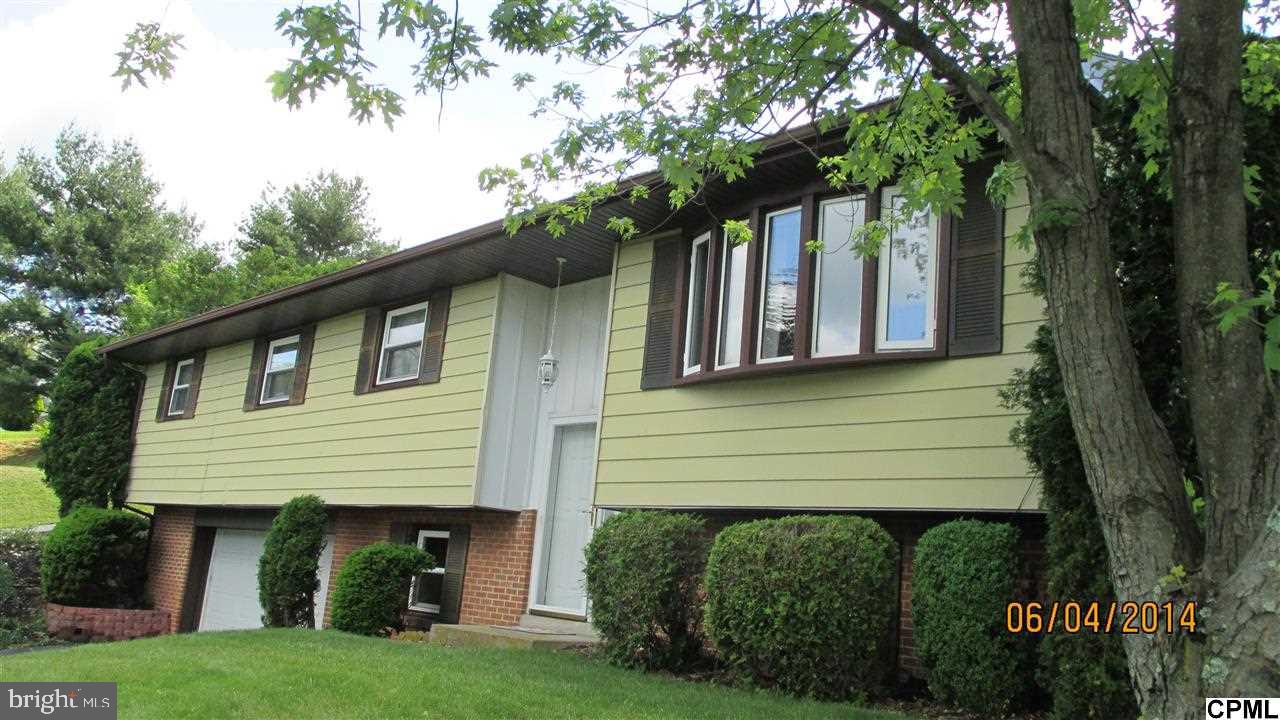 Wow! Beautiful 4 bedroom, 2 full baths, Bi-Level with an oversized 2-car garage. Over 2,000 square feet of finished living space. Formal dining room - walk out the back door from the kitchen on to a patio and a mature tree lined backyard. Lower level recently remodeled in 2011. Family room with wood fireplace. Newer A/C and Refrigerator. Plenty of space for a growing family. A must see!