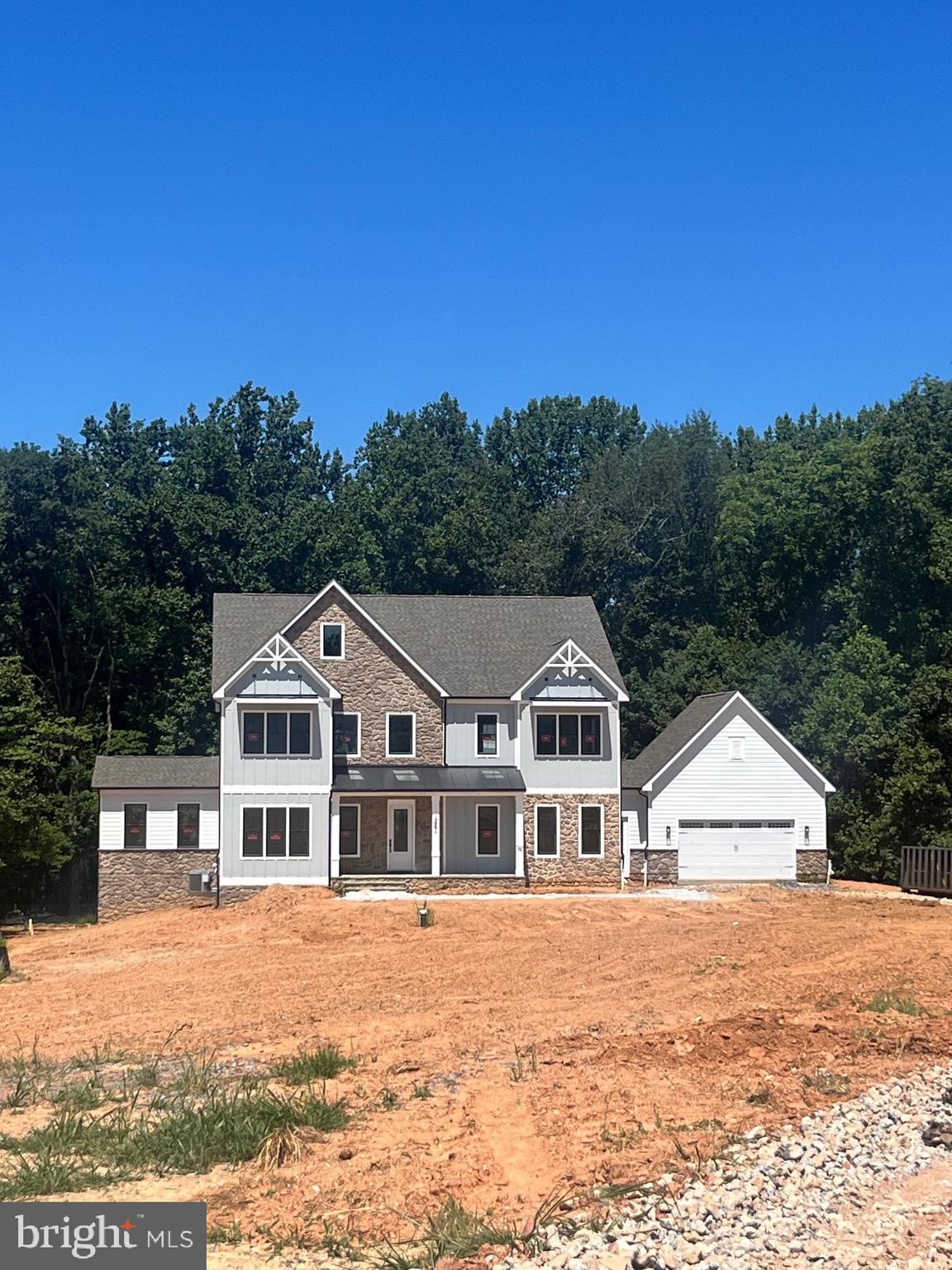 September 2025 MOVE IN!! Ask Abount our financing incentives! Meet the Hampton II which includes 6 bedrooms/6.5 baths with a 4-car garage and sits on a very private 1.5 acre homesite and backs to conservation area. Enter this home from a covered porch and view the soaring 2-story foyer. A flex room with French doors greets the entrance for use as you prefer- a home office or formal living room. The formal dining room is off the foyer and includes tray ceilings. Tray ceilings are additionally included in the family room and kitchen area. The kitchen and great room share the ever-desired open concept feel. Stay cozy near the contemporary linear fireplace and enjoy picturesque views from the double sliding glass doors. A conservatory is just off the family room. - perfect for holiday entertaining. The kitchen is complete with Aristokraft soft-close cabinets with below cabinet lighting and quartz counters. Fit for a chef this kitchen includes high-end KitchenAid gourmet appliances with a 36” gas cooktop, double oven or microwave/oven combo, double oven, dishwasher and French door refrigerator. 10 Foot ceilings are throughout the main level with 9-foot doors giving a airy feel throughout. The owner entry is positioned nearby and includes a drop zone. A private first floor bedroom is tucked away with walk-in closet as well as a main level full bath with walk-in shower. The solarium is off the family room providing gorgeous, wooded views. Oak stairs with iron balustrade led to the bedroom level. The primary is at the top of the staircase and is finished with a bedroom and sitting area with tray ceilings. Enter the primary bath through a generous hall through French doors. This bathroom will take your breath away! A walk-through glass front shower is the focus of this bath with double shower heads and a free-standing tub in front. Separate vanities provide plenty of storage with soft-close cabinets and quartz counter tops. A water closet is off to the side. Two generous walk-in closets are in this bedroom. Mohawk Revwood floors are featured in the hallway. For convenience, the laundry room is on the bedroom level which includes cabinets and a utility sink. Storage is abundant with two linen closets. All secondary bedrooms are generously sized and include a bath and walk-in closet. Secondary baths finished with 6x6 ceramic tile, soft-close cabinets and quartz counters. The basement is complete with a recreation room, full bath and basement bar. A video doorbell, Echo Dot, Zwave thermostat and door lock and wi-fi enabled garage door openers. July 2025 closing. *Photos not of actual home, and are of a similar model*