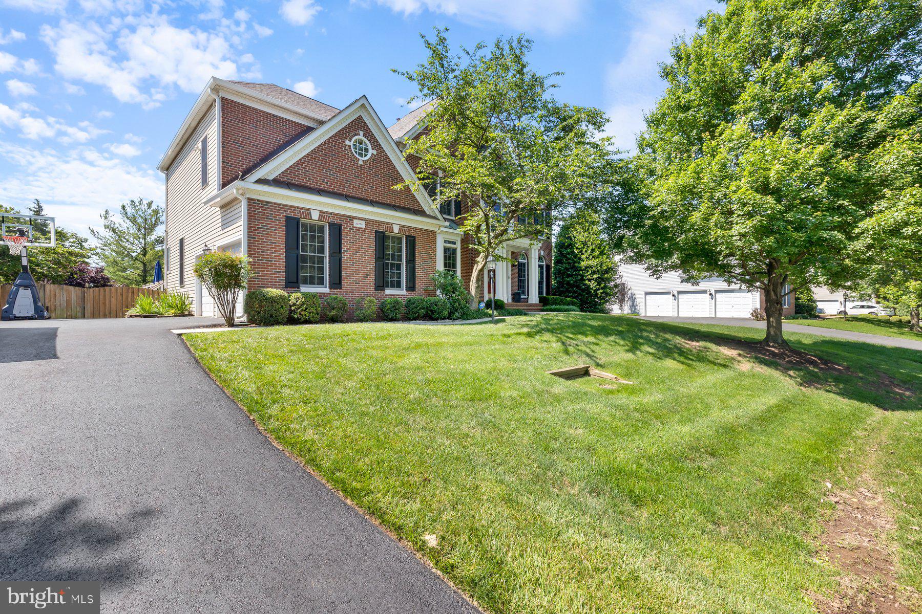 New Price! Same amazing home, even better value! Grand Living in Loudoun County’s Ashburn Station Community. You’ll want to hurry on this spectacular home with 4 bedrooms and 4.5 baths featuring 5,073 finished square feet of classic elegance blended with modern functionality and a sprawling resort-like exterior that makes daily living feel like a vacation. Several recent upgrades and improvements enhance the comfort, enjoyment and peace of mind residing in this home. Enter the home to a dramatic 2-story foyer and the warm and welcoming main level featuring artfully designed living, dining, and family rooms; a large office-study; and an elegant gourmet chef’s kitchen with a center island that seats 5, marble counters, butler’s pantry and a large kitchen pantry. Retreat from the generously sized sunroom to the wrap-around deck with steps leading to the stone patio and fully-fenced rear yard of nearly ½ an acre, providing the perfect setting for outdoor grilling, fun recreation and entertaining guests and friends. The upper level with an eye-pleasing overlook to the main level features a grand primary room with a private sitting room, walk-in closet and a spa-like bath with a soaking tub, separate shower and ceramic tile. 3 more generously sized bedrooms grace the upper level to include a Jack and Jill full bath and another full bath in the hallway. Time for more fun experiences and relaxation in the huge finished walk-out basement outfitted with an expansive recreation room with a wet bar, game room, bonus room that can be used as a 5th bedroom, full bath, and ample storage. Recent Upgrades and Improvements: Kitchen renovation 2020; upstairs HVAC replaced 2021; main floor HVAC replaced 2020; Water heater replaced with recirculation pump installed 2021; roof replaced 2020; Deck renovation including Trex RainEscape Dry System and under deck ceiling 2021; driveway resurfaced 2022; new 6” gutters installed 2024; Leaf Relief gutter guards installed 2024; new garage doors 2019; upstairs carpet replaced 2024; main floor and upstairs hallways painted 2024; installed primary suite closet organization system 2020; 4 toilets replaced 2023; 2025 Improvements: New dishwasher; all bedrooms painted; powder room sink replaced. Additional pleasures: Entire yard underground sprinkler system; radon mitigation system, 2-car side entry garage with auto-openers; asphalt driveway for 6 cars; main-level laundry room; fireplace. HOA includes trash service. This residence offers convenient access to an abundance of community lifestyle amenities such as the Dulles Technology Corridor; One Loudoun mixed-use retail, restaurants and entertainment; numerous parks, and trails; golf venues and most major errands. The Silver Line’s Ashburn Metro Station is just 1 mile away with direct access to DC, Tysons, and Dulles with community bus service to the Metro Station. More to see and experience. Shows Immaculate! See virtual video tour in listing. You’ll be proud to call this “Home”!