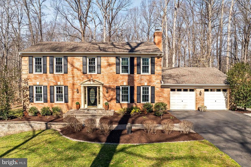 Welcome to this charming brick front colonial home nestled on a fabulous acre lot surrounded by mature trees.  A delightful hardscape entry leads you to the front door where you are greeted by warm hardwoods that sprawl through the formal living and dining rooms.  Here you will also find some crisp crown and chair moldings, an abundance of windows allowing natural light to flood the space, and a farmhouse style chandelier.  The spacious gourmet kitchen with peninsula exhibits gleaming granite countertops, and plenty of space for storage and prep.  Stainless steel appliances complete the utility aspect, while a lovely informal dining space provides a cozy nook for breakfast.
Step outside into the delightful screened porch with fabulous views of the rarely available in Fairfax Station, almost flat yard beyond, encapsulated with mature trees for privacy.  This space provides endless opportunities for relaxation or entertainment.  Back inside, a convenient laundry/mud room is located off the kitchen area, providing access to the 2 car garage,  and a spacious family room with custom built-ins, a brick surround fireplace, and an updated powder room completes the main level.
Upstairs you will find a large primary suite with walk-in closet, vanity area and an updated en-suite bathroom.  Down the hall, 3 additional bright and cheerful bedrooms, each with great lighting and plenty of closet space, share the beautifully appointed hallway bathroom.
The lower level comprises a storage room, kitchenette, sprawling recreation room with walk-out access to the patio and yard, and a bonus room that is very versatile completing this lovely home.  If you're looking for timeless elegance with a convenient location, you've found it here and welcome home!

Easy access to the Fairfax County Parkway, Route 123/Ox Road, commuter bus stop at entrance to the neighborhood, Burke Center VRE station minutes away.

Robinson Secondary and Oak View Elementary schools.

Community pool (memberships available), tennis courts, neighborhood pond, and walking trails.

Roof - 2012, Windows - 2017, HVAC - 2013 , Hot water heater – 2018.