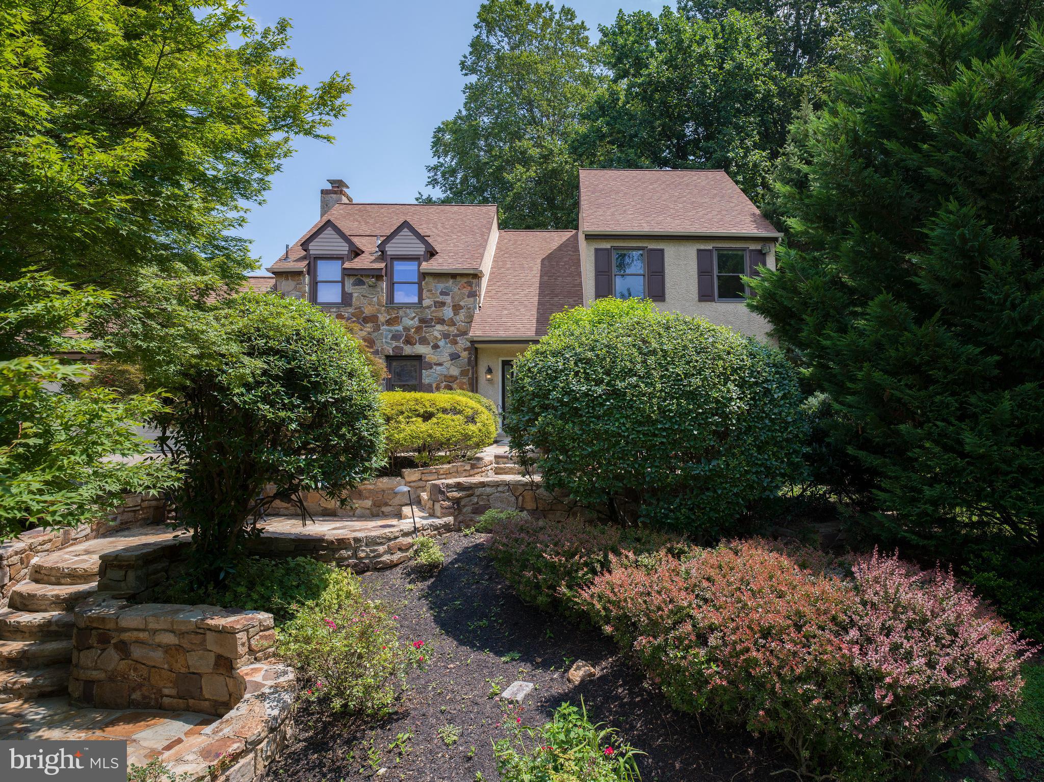 At the quiet end of a cul-de-sac in Indian Creek, one of Lower Merion’s most beloved neighborhoods, 920 Primrose Lane offers something rare: a home that feels both elevated and deeply rooted. It’s the kind of place where children ride scooters until sunset, neighbors greet each other by name, and a sense of belonging seems to live in the air itself.
From the moment you arrive, the setting draws you in. Mature trees line the property, and a tiered stone staircase guides you past lush plantings toward the entry. There’s a sense of natural privacy that makes you forget how close you are to everything.
Step inside, and you’re greeted by light. A soaring, two-story foyer opens the home with warmth and intention. Hardwood floors flow across the main level, guiding you from one generous space to the next. In the living and dining rooms, gatherings unfold with ease. A quiet dinner party. A milestone birthday. A Tuesday night that turns into something more.
At the heart of the home is the kitchen, where a wall of oversized windows frames peaceful views of the backyard. Morning light brightens the breakfast table. Afternoon conversations stretch long after coffee is poured. Every appliance has been thoughtfully updated, every detail chosen to make everyday living a little easier—and a little more beautiful.
From the kitchen, the home flows into a sun-filled family room anchored by a wood-burning fireplace and French doors that open to a stunning stone-walled patio. Just beyond, a recently renovated backyard deck and new built-in grill set the stage for effortless outdoor entertaining. It’s here where summers unfold: meals grilled and shared under the stars, weekend afternoons stretched out in the shade, quiet moments with a book and a glass of wine. The outdoor space feels enveloped in nature yet effortlessly livable, a natural extension of the home itself.
Tucked behind the kitchen, a renovated mudroom connects to the two-car garage and holds life’s rhythm in balance—backpacks, shoes, laundry, the movement of daily routines made seamless.
Upstairs, the primary suite offers a retreat all its own. The walk-in closet is spacious and smartly laid out, while the en-suite bath has been renovated with an eye toward calm: a walk-in shower, modern finishes, and a sense of quiet indulgence. Three additional bedrooms are filled with light and flexibility, while the hall bath—also recently renovated—offers a double vanity, walk-in shower, and soaking tub, ready for the start or end of a full day.
And then there’s the lower level. Fully finished, it expands the way you live. Today it’s a personal wellness sanctuary, complete with a gym and dry sauna. Tomorrow, it could be a media room, a game space, a guest suite, a home office—or all of the above. With its own full bath and open, finished layout, the possibilities are wide open.
Everywhere you turn, thoughtful upgrades elevate the experience. Central air keeps things cool, while brand-new mini-splits in two upstairs bedrooms provide additional comfort on demand. Every bathroom in the home has been beautifully redone. The garage and mudroom are fresh and functional. Nothing here has been overlooked.
But what makes this home most special can’t be captured by updates alone. It’s in the way light moves through the windows in late afternoon. The quiet that settles in as evening falls. The impromptu chat with a neighbor while checking the mail. The warmth of the Indian Creek community—a place where people stay because they want to, where connection comes naturally, and where families grow into the homes they love.