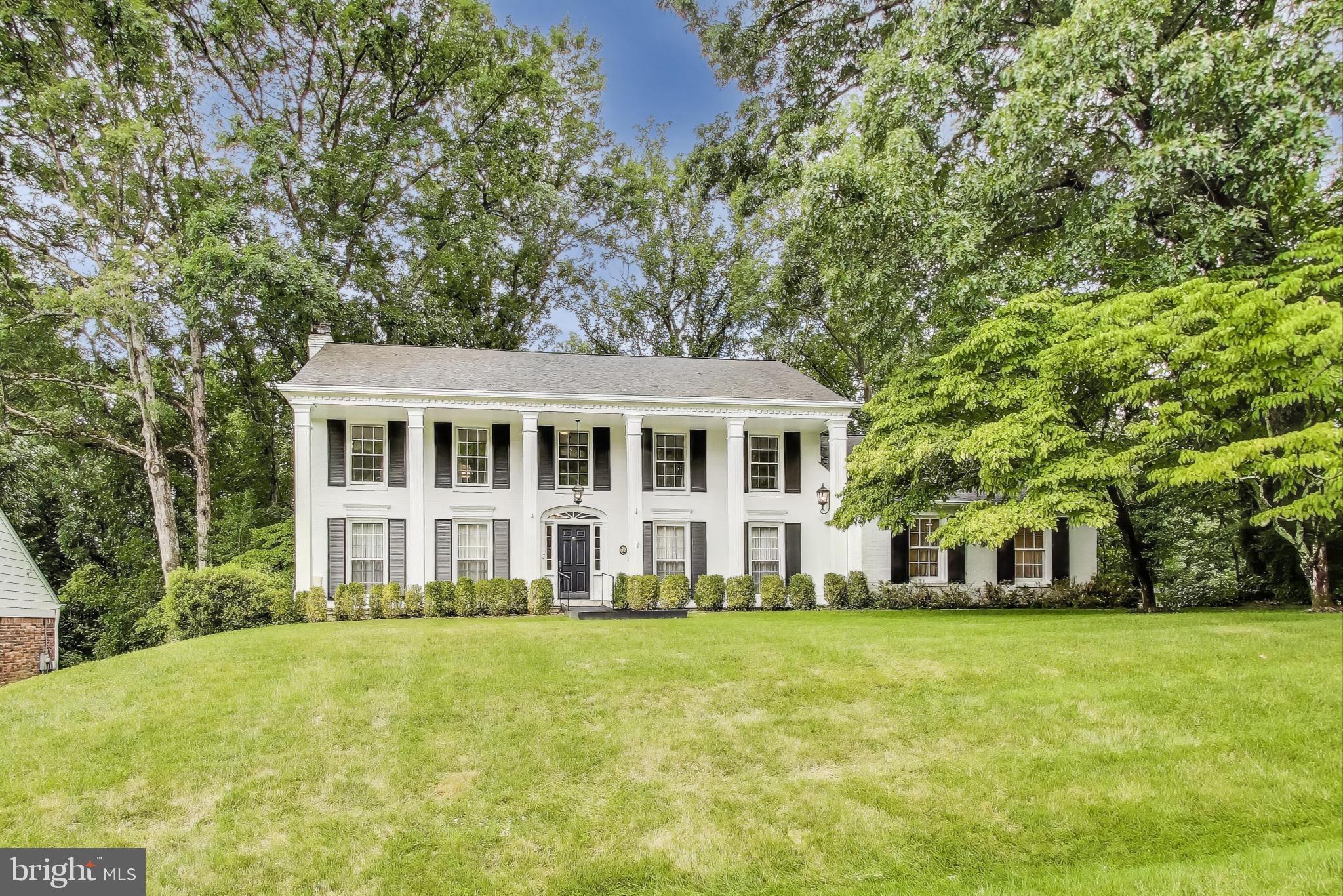 This expansive 6-bedroom, 3.5-bath home offers 6,195 sq ft of living space on a generous 0.43-acre lot with no rear neighbors—providing exceptional privacy and tranquility. Thoughtfully updated, the home features a stunning new kitchen with soft-close cabinetry, durable quartz countertops, and stainless-steel appliances. You'll also find freshly painted interiors, a renovated primary and hall bathroom, as well as new LVP flooring in the laundry room and a finished walkout basement with large storage room. The versatile layout includes three fireplaces, built-ins, and a seamless flow ideal for both everyday living and entertaining. The light-filled "treehouse" sunroom is a showstopper, with exposed beams and wraparound windows that bring the surrounding nature indoors. This room also provides access to the large deck. A generous home office with separate entrance completes the first floor. Upstairs, the spacious primary suite boasts a large walk-in closet with custom built-ins and a spa-like bath with soaking tub, dual vanities, and a tiled shower with bench and frameless glass door. All bedrooms are generously sized, and the hall bath also includes dual vanities. Enjoy the peaceful, wooded backyard with no rear neighbors, and plenty of parking on the extended driveway—plus room for a future garage if desired. Designed with inclusivity in mind, this home includes a residential elevator that connects the main level and finished basement, a hardwired generator for peace of mind, and wide doorways with open, barrier-free spaces. There are ramped entrances to both the first floor and basement, accessible bathrooms on both levels, and a flat parking pad for easy mobility. The flexible home office includes a roll-under workstation and floor outlets for freely placed equipment. The finished basement offers a private suite—ideal for an au pair, caregiver, or multi-generational living.