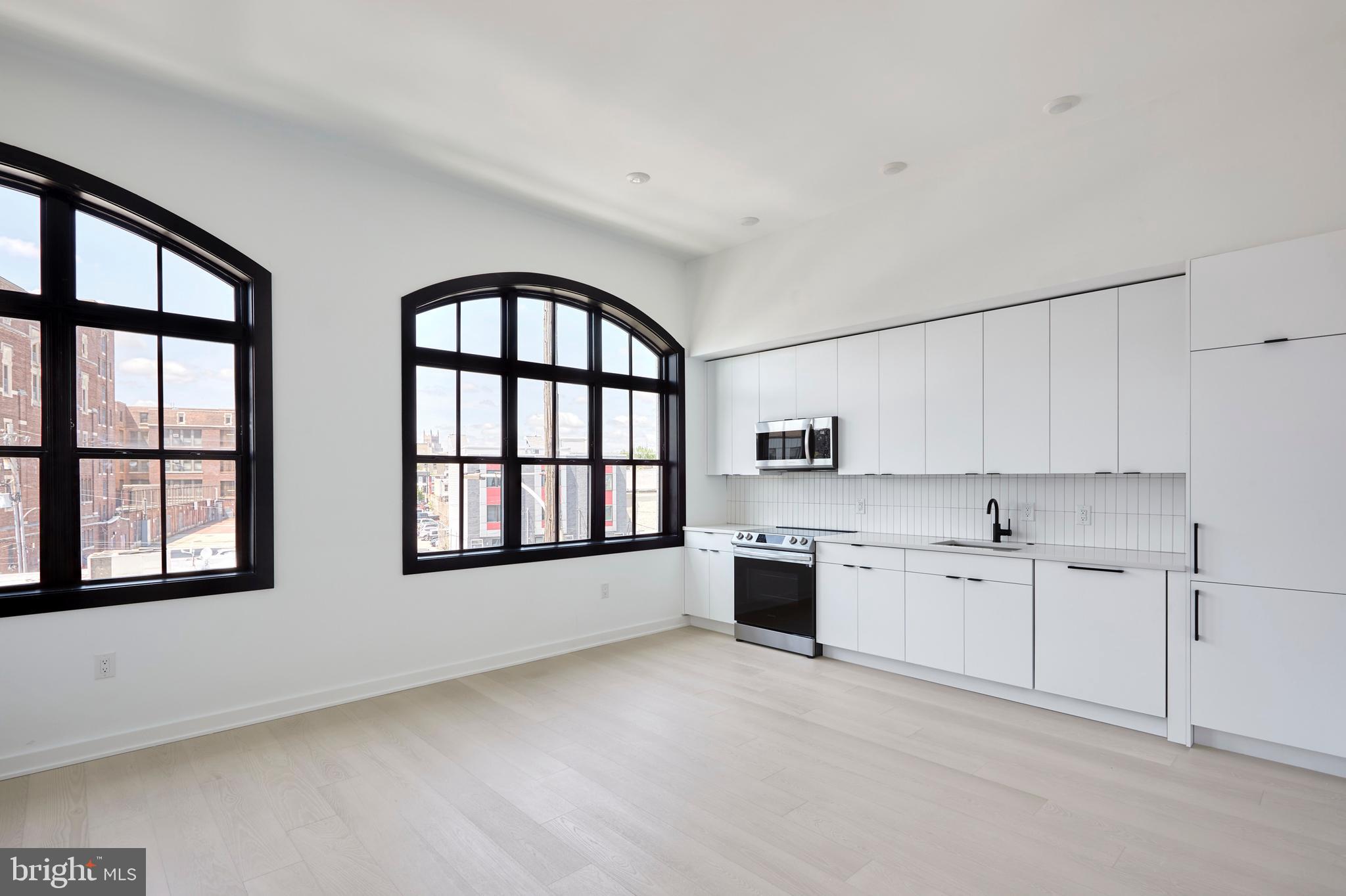 Now offering 1 months free on an 16 month lease! Price reflects 1 months free on a 16 month lease, base rent price is $1650.00. Welcome to 2525 Frankford Avenue, a stunning new construction building meticulously designed and developed by top local developers. This exquisite residence boasts an abundance of natural light that floods through its expansive windows. As you enter into the unit, you are welcomed by an abundance of natural light boasting from the massive factory-style windows. As you walk through the entryway and down the hall, you'll find the modern bathroom with white subway tile throughout the shower/tub combo, black delta finishes, and a floating vanity allowing for extra storage. The high ceilings throughout the living space continue into the bedroom which offers a large closet for storage, and ample space to comfortably fit a queen sized bed! The spacious, open concept kitchen and living area offers plenty of room for a sectional and/or dining table right by the enormous windows overlooking Frankford Ave. The European style kitchen is equipped with quartz countertops and panelized appliances. Full- sized washer and dryer in-unit for your convenience! Conveniently located to near all that Fishtown has to offer including Vessel Coffee Collective, Fiore, Martha, Philadelphia Brewing Company, Post Haste, Forin, and the brand new Picnic. Come see what Fishtown and 2406 Frankford have to offer you! Pet friendly! Tenant pays electric and water.