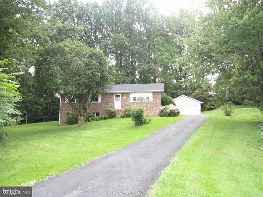 Well built all Brick home close to beach!  3 bedroom 2 bath home sets on .60 acre with a 2 car detached garage and paved driveway.  Sunroom off the back.  New Roof, new Furnace, new carpet and freshly painted.  Windows are also newer.  Beautiful brick fireplace is in the basement.  Private lot, but super close to Beach and Shopping. No HOA! Must see to appreciate!