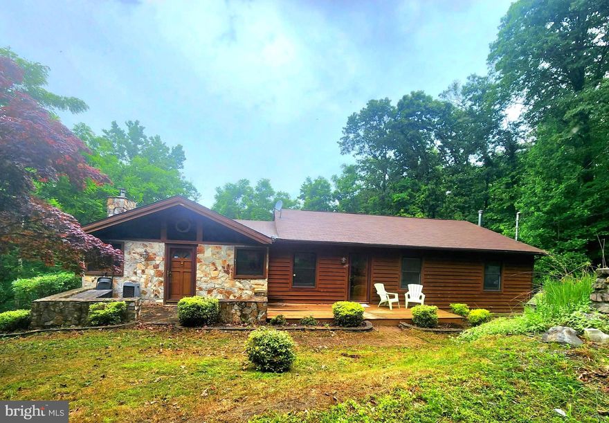 This home has so much to offer.  Must see this spacious Cedar & Stone raised ranch home situated on secluded .61  wooded, private acres located in  Harpers Ferry.  Home features 3600 total square ft, and the 3300 sf of living space includes 4 bedrooms and 2 baths. The addition, built in 1994 features a Huge Living Room with beautiful vaulted  wood beamed ceilings, cozy stone hearth fireplace  and lots of windows to let in the light! The upper level enclosed porch, just off the living room has many windows that lets in the natural light.  Open up the windows and enjoy the breeze and let the Cicadas and birds serenade you.  This area could make a nice office,  plant room , craft room or sitting room, so many possibilities. The open concept kitchen, remodeled in 2012  has tons of cabinet and counter space, stainless appliances and a bar area with room to sit.  Den/Dining area just off the kitchen for those who prefer a little more formal dining or perhaps a reading room or sitting area.   Primary bedroom has a full bathroom and  French doors opening to it's own private deck.  The lower level  is fully finished with a huge family room and wood burning stove, an over sized 4th bedroom,  and  recreation room with wet bar.  Back yard has a large shed with room for all your tools and toys. Lots of mature trees offer privacy and shade.   Just minutes from Lake Shannondale,  the Shenandoah River,  and  Appalachian Trail Access. Convenient to historic downtown Harpers Ferry and the  Harpers Ferry/Brunswick Marc Train.   Just a short drive  to the Hollywood Casino at Charles Town Races.  Perfect work from home location offering Comcast High Speed Internet. So much space,   so many possibilities.  Call for your showing today!