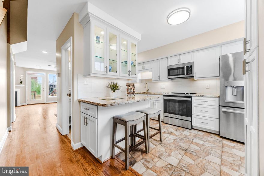 Welcome to your new home nestled on a cozy cobblestone street of Washington Village! This beautifully renovated four-bedroom, 2.5-bathroom row home offers the perfect blend of historic charm and modern convenience. It's not often you can open your door to overlook old train cars as you take in the sights of the B&O Railroad Museum from your stoop. As you step through the door, you're greeted by gleaming hardwood floors that flow throughout the home, creating an inviting atmosphere. Large windows flood the space with natural light, highlighting the thoughtful attention to detail in every corner. The newly renovated kitchen boasts updated stainless steel appliances and ample counter space for meal prep on granite countertops. Relax in your spacious living room while enjoying the warmth of the fireplace, or step outside to discover your own private oasis—a back deck with patio where you can garden or enjoy a quiet cup of coffee in the morning. Upstairs on the second level you'll find two spacious bedrooms sharing a full hall bath. On the third level you will find an expansive suite with natural light flooding through the large bay windows along with the fourth bedroom and shared hall bath. Either floor can be made into a primary suite with ensuite bath and office space, or find that the 4 rooms are perfect for sharing the home amongst students. The basement offers ample potential as a secondary living space or simply come down to do your laundry in the separate laundry room with additional cabinetry.  The entire home boasts brand appliances, windows, carpets and cosmetics throughout. If you are looking for a home with quick walk to the UMD campus or simply downtown, this home is perfect for renters or families alike. Situated on a charming cobblestone street, this property offers a unique glimpse into Baltimore's rich history with direct views overlooking the iconic B&O Railroad Museum while still allowing for quick access to all major highways and public transit options.