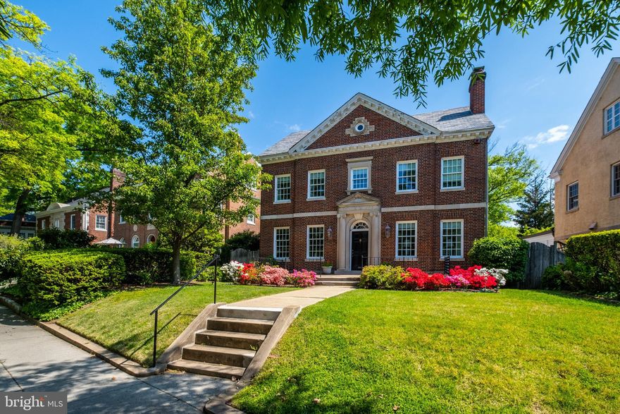 Neighborhood treasure! Beautiful brick and limestone Harry Wardman Georgian home features an expansive, airy floor plan with grand-scale rooms and lovely architectural details inside and out! Main level with 9' ceilings features enchanting library, double living room with fireplace, elegant dining room with walkout to back garden, powder room/wet bar, and large, sunny kitchen. On the second floor is a primary suite with two full baths and dressing room, large bedroom with fireplace, office (could be additional bedroom), and additional full bathroom. The lofty third floor features two generous bedrooms, full bathroom, and bonus room with porthole window. Spacious lower level with access to 2-car attached garage. Serene and private back garden with patio and deep front yard with large terrace. Steps to schools, metro, shops, & restaurants!