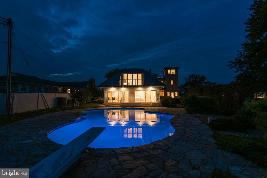 Views from everywhere! Whether you're relaxing by the pool, chatting on one of the many balconies or taking it all in from the lookout... this one-of-a-kind custom home has it ALL! Boasting main level masters, elevators both inside and out, breathtaking mosaic pool, boat lift, sandy private beach, top-of-the-line Pella windows and doors throughout.. location AND quality on nearly an acre!