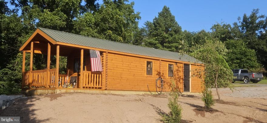 Rustic One-Bedroom Log Cabin — Mountain Retreat 17 Miles from Winchester
Escape to this charming and efficient log retreat nestled atop a scenic mountain ridge. This one-bedroom, one-bath gem features an open great room adorned with exposed log beams, a cozy bedroom, and a compact but functional bathroom. Laundry and storage are thoughtfully incorporated for practicality. Enjoy serene mornings on the porch, soaking in forested views, and evenings by a wood-burning hearth—whether you're unplugging for solitude or hosting a quiet getaway. Despite its peaceful, elevated perch, the cabin remains just a short drive from Winchester, offering a perfect balance of escape and accessibility.