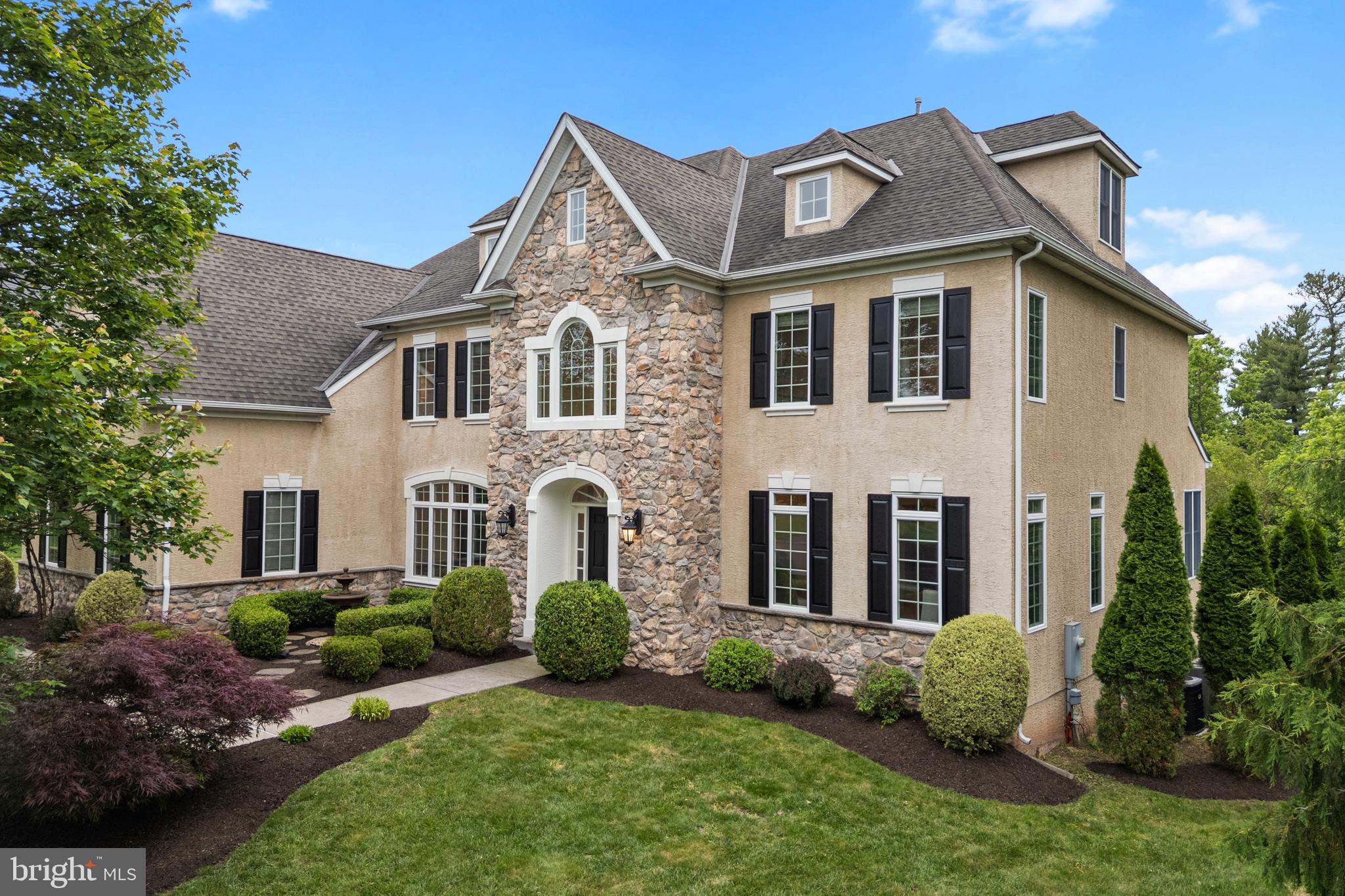 Extraordinary Guidi built home in highly desirable Preserve at Skippack. This exquisite closely knit neighborhood just feels like luxury with a large double cul-du-sac and useful common area which serves neighborhood kids, picnics, special events and social hour when walking your pet. The community was well designed with the front of the house facing the park-like community grounds with gazebo, surrounded by community walking paths and each neighboring home compliments one another’s curb appeal. The commonly held natural preserved acreage which includes a stream holds abundant wildlife and serves as an endless playground for kids. Inside this 4+ bedroom Colonial with an open floor plan you’ll discover many upgrades including a finished walkout lower level and a finished 3rd floor bonus room fully heated and cooled . This Newbridge French Country Model was gorgeously planned out by the homeowner and builder with the distinct quality and taste. The 1st floor boasts impressive 8’ doors, double access staircase, and a large open 2nd story foyer open family room with gorgeous stone fireplace. You’ll also find freshly refinished hardwood floors, custom millwork and a luxurious and appealing living space due to the craftsmanship and design of high ceilings and window placement. Double doors lead to a large main floor office with walk in closet which also could perform as a main floor bedroom. The outstanding gourmet kitchen features hardwood flooring, large center island with seating for three, pendant lighting, granite counters, a new double stainless wall oven, oversized stainless sink with garbage disposal, 5 burner gas stove with hood, stainless dishwasher, 42" century cabinets and a walk-in pantry closet. The Breakfast area is open to the family room and access to the updated Trex deck (2024) where you can enjoy an expansive view of the “green belt” wooded area offering a peaceful and serene setting. The mud room includes built in cabinets, closet, and stainless utility sink. Upstairs, the primary suite is located at the rear of the home rather than over the garage which offers a retreat with views, a sitting area or 2nd office with dormer windows as well as a 2nd walk-in closet. The space could also be used for additional closets or a nursey room. The tiled bath offers a whirlpool tub, a tile stall shower, double vanities and a linen closet. Three additional bedrooms with carpet and walk-in closets including one with an en-suite full bath, and 1 Jack and Jill bath connecting the other 2 bedrooms. The additional 3rd story bonus area offers so much!!! It could be a game room, large home office, 5th and 6th bedroom, a 2nd suite if plumbing was added to the space. The appealing custom walk-out finished lower level provides entertaining opportunities. With dedicated and uniquely designed spaces to serve a multitude of uses. One of the spaces could be a glorious media, game or exercise room. While another area could be used for an additional bedroom or living space as it has a full bath. The natural window light makes the lower level welcoming and leads well to current outdoor space with new custom patio uniquely designed and is ideal for entertaining, it could become a ‘dry space’ where potentially you could use it as an all-season space. If you desire large gathering spaces this home has it all. There is also an abundance of storage options. The home is properly zoned for heat and air, the lighting throughout is and all LED and the windows were upgraded to Anderson 400 Series. The Location of the neighborhood is minutes to the 476 Harleysville/Lansdale Entrance taking you to King of Prussia, Plymouth meeting and East to Willow Grove area within 20-40 minutes. Harleysville and neighboring Lansdale, Skippack and Souderton offer so much do do. This home doesn’t just feel excusive… it is exclusive. This neighborhood was also recently voted “Neighborhood of the Year.”