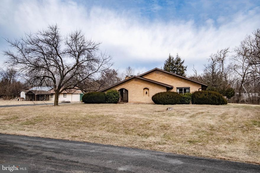 Pending Release-Lender Dropped The Ball. All Brick Rancher In Sought Out Bunker Hill WV!  Home Sits On 2 Parcels Equaling Approximately 4.55 acres.  Custom Built in 1976, Milled Hardwood Floors, Open Spacious Living Room and Family Room.  Kitchen Cabinets Handmade and In Great Condition! Open Floor Plan, 3 Oversized Bedrooms, 2 Full Bathrooms, Walk In Closets, Family Room With Fireplace and Built Cabinetry With Wet Bar!  Outside There Is A Huge 24x20 Workshop With 2 Attached Sheds. Property has Well/Septic On It, But The House Is Fed By Public Water and Public Sewer.  Septic system still exists on property but not used.
Such A Unique Home With All Brick Walkways and Iron Decorative Gates. Small Shed Attached To House Also, Currently Used As Storage And Has Extra Freezer In It. Close To Rt 81! Amazon, Proctor Gamble, Frederick County VA Line, Marc Train In Martinsburg. In Addition, The Driveway Is A Shared Driveway.
