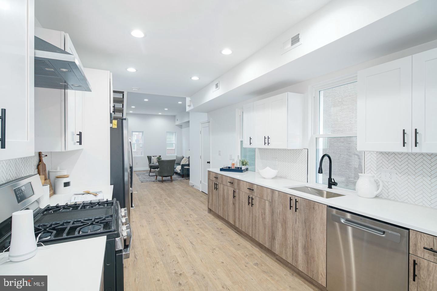 Where Style Meets Comfort in the Heart of Francisville! You don't want to miss this stunner with 6+ years of tax abatement (ending in 2032), This impressive 3-bedroom, 2.5-bathroom townhome offers 2,100 sq. ft. of thoughtfully designed living space, including a fully finished basement that can serve as a fourth bedroom, home office, or workout space. Every detail has been carefully curated to blend modern elegance with everyday functionality. Step inside to an open-concept living area with high ceilings and oversized windows flooding the space with natural light. The chef’s kitchen boasts two-toned cabinetry, sleek black fixtures, a custom backsplash, and stainless steel appliances, including a spacious island for prep and gathering. Sliding glass doors lead to your private outdoor patio, perfect for summer nights and weekend brunches. The second floor features two spacious bedrooms with ample walk-in closet space and large windows. A beautifully designed full bathroom ties the space together with black fixtures, a large vanity, and elegant ivory textured tile. The third floor is your personal sanctuary—a primary suite with a walk-through closet and a spa-like ensuite with double vanity, soaking tub, and marble hex tile finishes. And just when you think it couldn’t get better—step onto your private rooftop deck. With prime location and luxury finishes throughout, this home is a rare gem. Schedule your showing today!