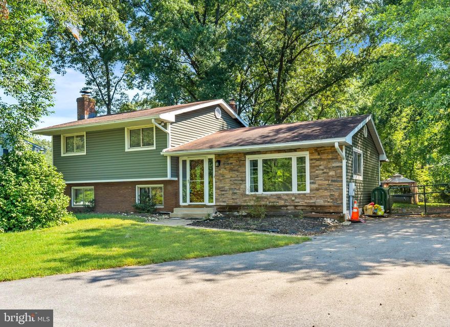 Delightful home, brimming with original charm and character! As soon as you walk into this home, you are greeted with a bright and airy living room that opens to the dining room and kitchen - perfect for entertaining!  Gorgeous kitchen overlooking the backyard features a breakfast bar, new stainless steel appliances, and tons of storage and prep space! Primary suite with large closets and a chic bathroom featuring a stall shower and dual vanities. The additional spacious bedrooms are located on the top level as well. Additional living space in finished lower level with a fireplace and extra storage space. Large deck with walk out to the generously sized backyard with a hot tub and be sure to check out the creek - great for outdoor fun! Also new vinyl siding! Conveniently located next to 97 and Maryland 100 , plus shopping, restaurants, and entertainment just minutes away, what more could you ask for! Schedule your showing today!