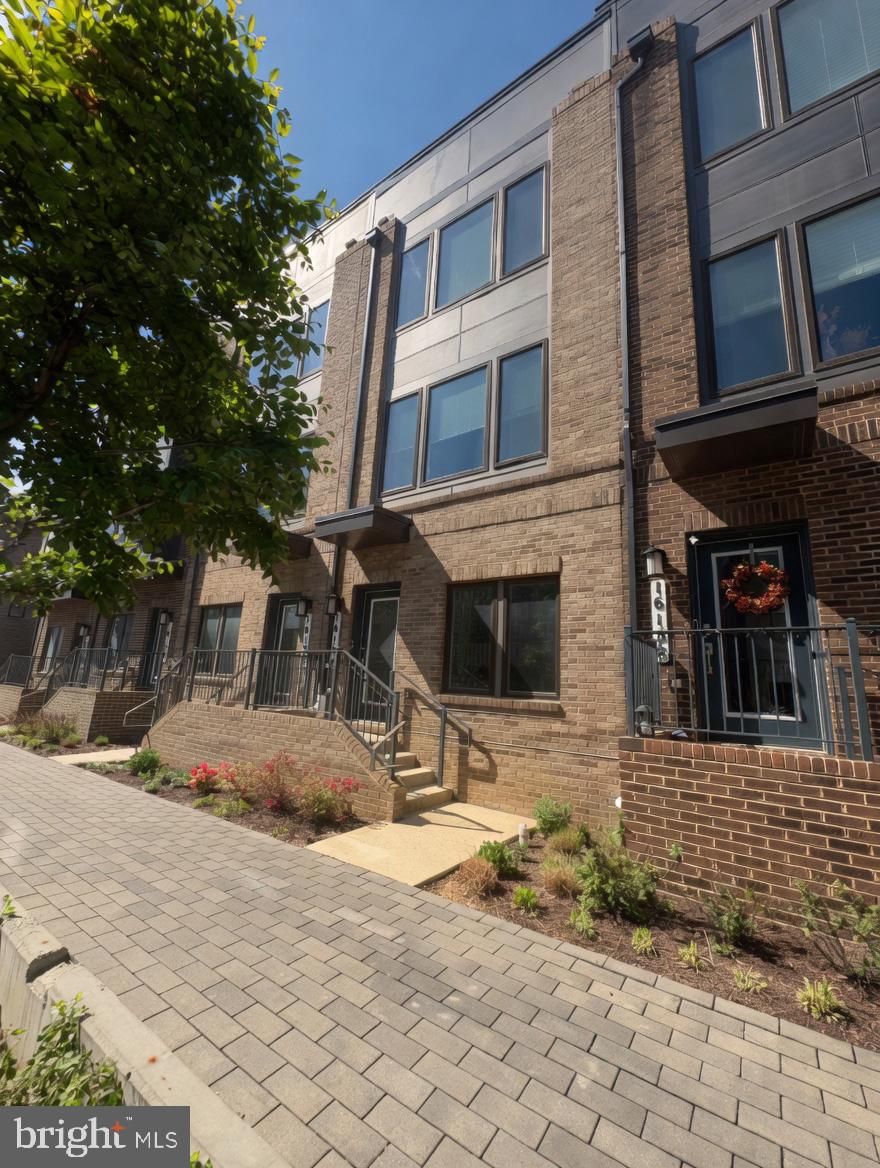 Modern, well-designed, and spread across four finished levels, this 3-bedroom, 3.5-bath townhome built in 2021 offers a flexible layout, contemporary finishes, and multiple private outdoor spaces.

The main living level features a true open-concept layout with a natural flow from front to back. The living room, complete with an electric fireplace, sits at the front and connects seamlessly to the centrally located kitchen, featuring a large island with bar seating, quartz countertops, stainless steel appliances, and generous cabinetry. The dining area opens directly to a private balcony, creating an easy indoor-outdoor setup. A powder room is also conveniently located on this level.

Upstairs, the bedroom level is thoughtfully arranged to maximize privacy. The primary suite includes a walk-in closet and an en-suite bath with dual vanities, a glass-enclosed shower with bench, and a private water closet. A second spacious bedroom also features its own en-suite bath. Laundry is located on this level for convenience.

The top floor adds valuable flexibility with a large bonus living area, a third bedroom, and a full bath, ideal for guests, a home office, or additional living space. This level also provides access to a large, private rooftop terrace.

The ground level includes access from both the front door and the attached two-car garage.

Located in Westside at Shady Grove, just minutes from the Shady Grove Metro Station, the community offers a range of amenities including a pool, fitness center, clubhouse, and playgrounds. The nearby Downtown Crown, Rio Lakefront, and Rockville Pike provide extensive dining, shopping, and daily conveniences. With easy access to I-270 and the ICC, commuting to D.C. and surrounding areas is straightforward. A modern layout, strong location, and low-maintenance lifestyle all come together in one complete package!