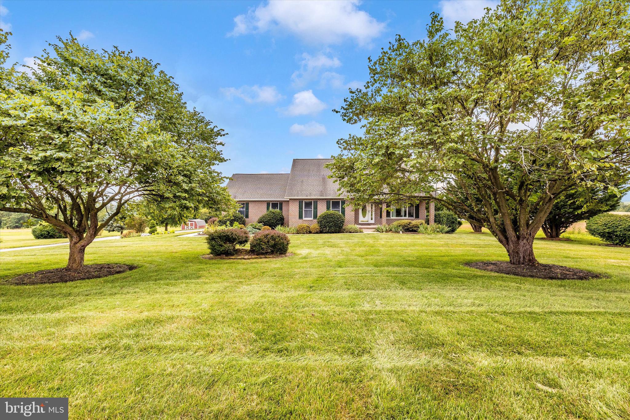 Nestled on nearly 2 private acres near the scenic and historic Utica Covered Bridge, this beautifully maintained custom full-brick home offers timeless craftsmanship, modern updates, and serene countryside living.
Built in 1998, the home welcomes you with a charming deep front porch with all brick posts—the perfect spot to enjoy your morning coffee. Inside, rich hardwood floors flow through the sun-filled living and dining rooms, with a cozy propane fireplace adding warmth and character. Step outside to a low-maintenance synthetic deck and take in the peaceful views of neighboring farmland.
Pride of ownership shines throughout, with numerous recent updates, including: a whole house generator (2022), new furnace (2022), renovated primary bath (2023) with soaking tub & glass-enclosed shower and kitchen updates (2022) featuring quartz countertops, stylish backsplash, new range hood and refrigerator. The owner has most of the manuals and service providers to provide to the buyer.
The spacious main-level primary suite boasts upgraded carpeting, two walk-in closets, and abundant natural light. A dedicated laundry room and guest powder room complete the main floor for convenient one-level living.
Upstairs, you’ll find two generously sized bedrooms and a full bath—perfect for family or guests.
The finished lower level includes a welcoming rec room with pellet stove, dry bar, cold cellar, and a half bath with shower rough-in, offering excellent potential for future expansion.
An oversized two-car garage with a built-in workbench provides ideal space for hobbyists, DIYers, or anyone needing extra storage.
This home blends rural tranquility with thoughtful upgrades—just minutes from scenic trails, commuter routes, and the charm of historic Frederick County. Schedule your tour today!