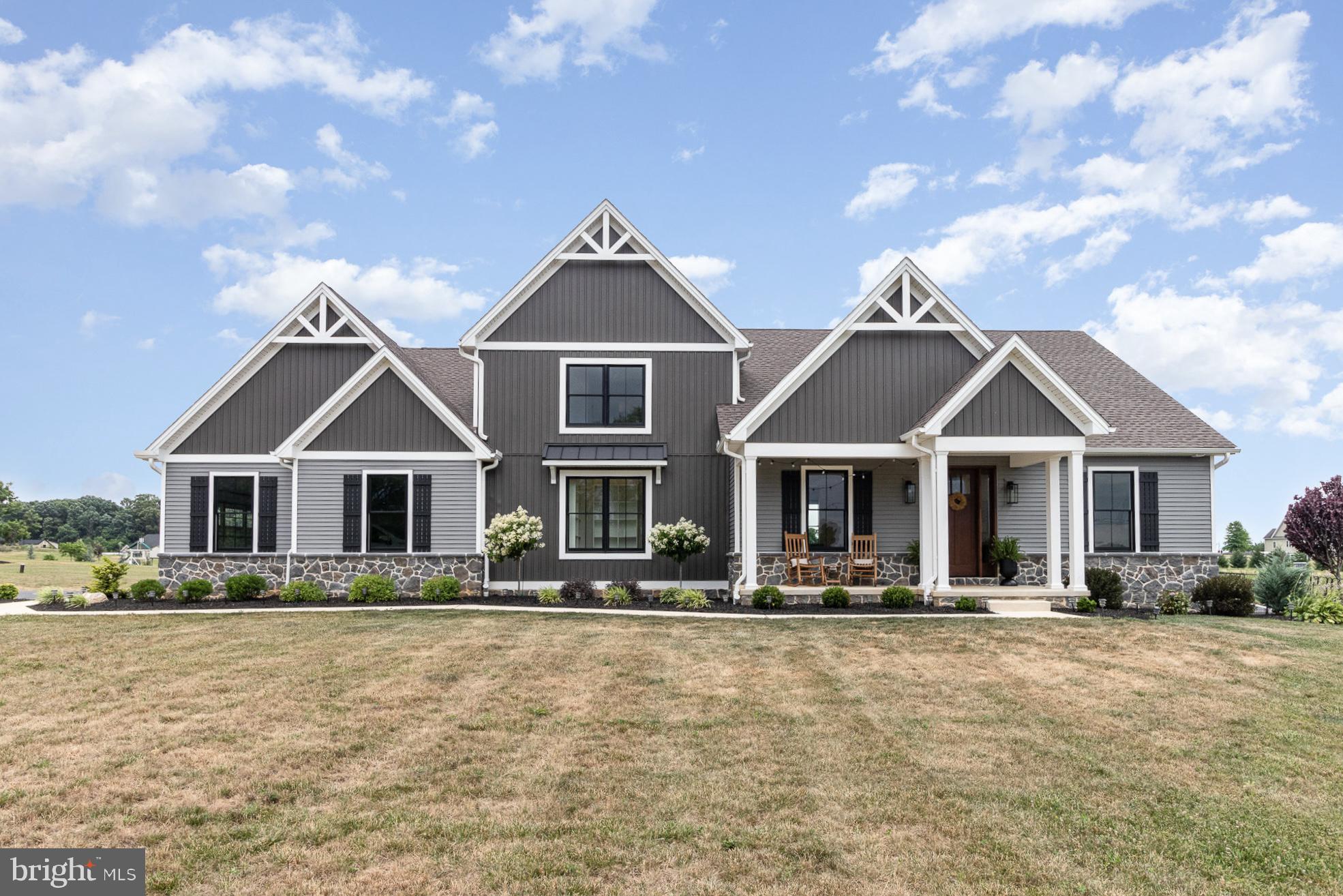 Welcome to this exquisite contemporary craftsman estate, nestled on 2.46 acres in the coveted Lindenwood community, offering breathtaking panoramic views of the Cumberland Valley. This meticulously designed home combines luxury with functionality, boasting an oversized 3-car garage and a striking exterior featuring vertical and horizontal siding, complemented by black Andersen 400 Series double-hung wood-frame windows.
Upon entering through the impressive 8-foot stained front door, the high-grade hickory LVP flooring leads you into the expansive living area, highlighted by expansive windows framing picturesque rear yard views. A sophisticated office awaits with two sets of sliding glass barn doors, perfect for style and convenience.
The private first-floor master wing is a sanctuary, featuring exposed beams, a cathedral ceiling, and abundant natural light. The master bathroom offers double vanities, a linen closet, a custom oversized tiled shower, and a spacious walk-in closet with designer shelving.
The living room captivates with its cathedral ceiling adorned with wood-stained exposed beams, recessed lighting, and a propane fireplace finished with a fieldstone profile and a stained beam mantle. The gourmet kitchen is a chef’s dream, featuring a massive 10-foot by 4-foot custom island, stained wood floating shelves, stainless-steel appliances, high-end granite countertops, and high-grade extended-height recessed wall cabinetry. An oversized walk-in pantry provides additional storage, complete with high-grade cabinetry, granite countertops, outlets for appliances, a built-in beverage cooler, and excessive shelving.
Adjacent to the kitchen, a dedicated mudroom offers convenience with cubbies for storage and stair access to the full-footprint basement, featuring a Superior Walls foundation and outdoor access. The spacious dining room, with Andersen Frenchwood Sliding Door access to the large rear covered porch, is ideal for entertaining with abundant natural light and views of the expansive rear yard.
The first floor also includes a dedicated laundry room with cabinets and shelves for added convenience. Upstairs, three spacious bedrooms each boast ample closet space. Two of the bedrooms are complete with large walk-in closets and a Jack-and-Jill full-bath with a double vanity. The third upper bedroom includes an en-suite full-bath and a spacious closets, ensuring comfort and privacy for all residents.
Every bedroom in this exceptional home features an attached bath, and the home benefits from three heating-and-cooling zones and an energy-efficient dual-fuel heat system. This distinguished residence is a testament to premium craftsmanship, a collaboration by Artisans Design Build and Hutch Homes, and was honored with the 2022 Best Custom Home Award in its price point by the Home Builder’s Association. How many other homes have a private resident's paved walking trail in their backyard? You won't want to miss seeing this impressive home in person.