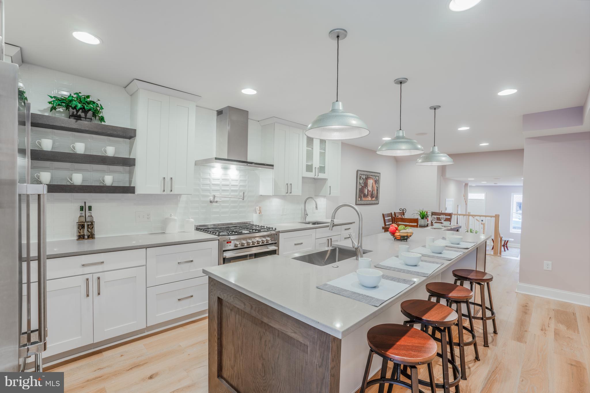 Stunning CHAP Tax Credit Renovation in the heart of Canton offering everything in city living! This 3 bed 4.5 bath home features an open front to back layout, beautiful engineered hardwood flooring, dual zoned HVAC system, tankless water heater, first floor half bath, second level laundry and two car parking to name a few. Enjoy a large chefs kitchen with two deep sinks, high end stainless steel appliances with a 36" range and hood vent, pot filler, and plenty of storage and pantry space in custom cabinets. Second level has two bedrooms, one with a lofted set-up, very high ceilings and tons of natural light while the other is a master suite with enormous walk-in closet, private bath, dual vanities and standing glass shower. Third level shows off another master suite with large bedroom, walk-in closet and additional living area perfect for entertaining with your own wet bar, extra refrigerator and access to a rooftop deck with sweeping 360 degree views. Tax credit will save you over $7850 in taxes per year! Just a short walk to all of the stores and shops in Canton Crossing, canton squares restaurants, bars and easy access to I-95 for commuters. Another great home by local builder KT HOMES, one year builder warranty with acceptable contract. Set up a showing today!