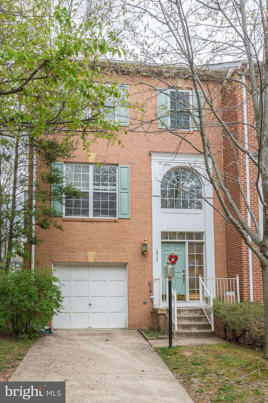 Welcome to this charming sun-drenched end unit with attached garage. Elegant two story foyer. Hardwoods throughout main level. Updated gourmet eat-in kitchen w/ gas cooktop island and fireplace.  Kitchen opens to deck overlooking wooded area.  Walk out lower level w/ lovely finished family room. Large master bedroom w/ high ceilings and attached master bathroom with soaking tub and separate shower