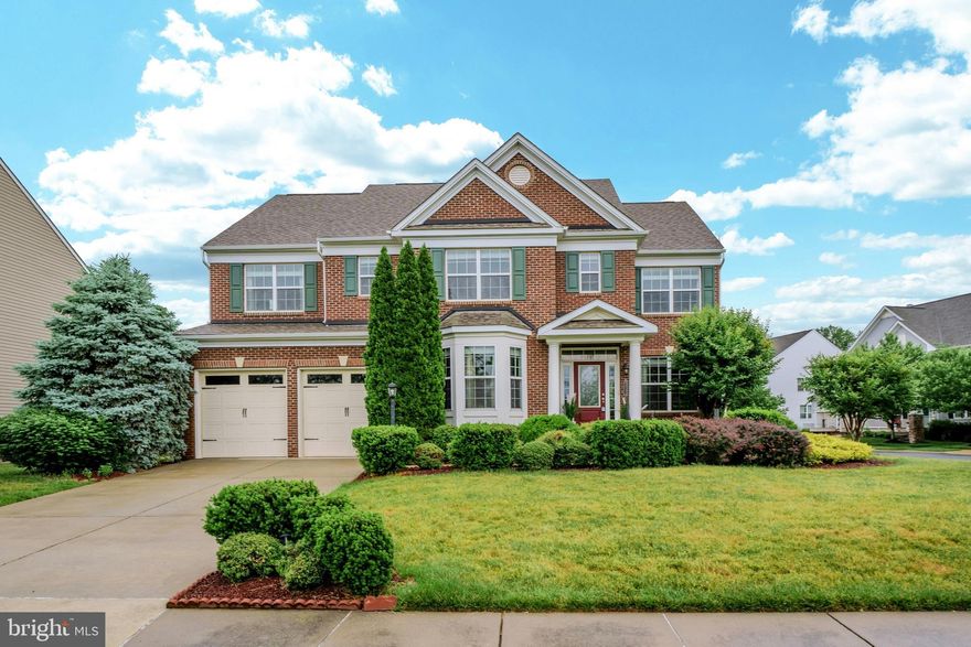 Welcome home to this stunning former model home built by Beazer Homes featuring 5 bedrooms, 4.5 baths & over 4,800 square feet of well-appointed living space conveniently located in the highly sought after Brambleton community! This home features custom paint, upgraded lighting, upgraded flooring, detailed moldings & other custom finishes throughout. The covered entry greets you as you enter this stately colonial. Private main level office with custom built-ins provides an incredible work from home space. Elegant living room & formal dining rooms both feature bay window bump-outs. Chef's kitchen with tons of cabinetry, stainless steel appliances, center island with breakfast bar, gas cooking, under cabinet lighting & large eating area. The expansive great room features gas fireplace with stone surround & leads into the light & bright sunroom with vaulted ceiling. The main level features a private powder room as well. The oak staircase with carpet runner & iron ballusters leads you to the upper level. Large primary suite with sitting area,two walk-in closets & spa inspired bath with soaking tub & separate shower. The second and third bedrooms shared an upgraded bathroom. Fourth bedroom with private ensuite bath & laundry room with built-in cabinetry completes the upper level. Finished walk-up lower level with huge recreation room ideal for entertaining, 5th bedroom/media room with walk-in closet, 4th full bath & storage. The low maintenance deck with pergola leads to the large custom patio all overlooking the fenced rear yard. Mature landscaping surrounds the property including apple trees! Additional upgrades include hot water heater (2024), washer & dryer (2022), whole house water filtration, radon mitigation system, home security system & more. Sought after school pyramid of Madison's Trust - Waston Mountain/Brambleton Middle School - Independence High school. The amenity rich Brambleton community offers pools, walking paths, fitness center, basketball courts, playgrounds, year-round events & more. High speed internet is included in your monthly HOA fee as well. This incredible location within the community offers convenience to Hanson Park, Brambleton Town Center with shopping & dining, nearby schools & commuter routes.