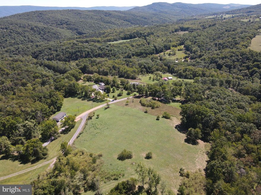 CALL NOW TO SEE THESE  9 CLEARED, WOODED AND ROLLING ACRES WITH A BREATH TAKING VIEW OF THE SURROUNDING  MOUNTAINS AND TOPOGRAPHY.  A WELL IS ALREADY  IN PLACE,  THE DEPTH IS 260 FEET AND IT IS PRODUCING 12+ GPM.   MANUFACTURED / DOUBLE WIDE HOMES ARE ALLOWED HERE IN THE FRUIT RANCHES. YOU JUST NEED TO HAVE A PERCOLATION TEST. IF YOU ARE LOOKING  TO  FIND  AN ESCAPE FROM THE RAT RACE THEN COME TO WEST VIRGINIA WHERE YOU CAN LIVE FREE.  ENJOY WATCHING THE CONSTELLATIONS, STARS, MOON , SATELLITES AND MAYBE SOME METEORITES.   LET THE DEER, RABBITS, SQUIRRELS, TURKEYS AND OTHER ANIMALS BE YOUR NEIGHBORS. FOR THE AVID OUTDOORSMAN WHO ENJOYS HUNTING, FISHING OR KAYAKING, THE NATHANIEL MOUNTAIN WILDLIFE MANAGEMENT AREA  AND THE SOUTH BRANCH OF THE POTOMAC RIVER ARE ALL LESS THAN A 5 MILE DRIVE AWAY.