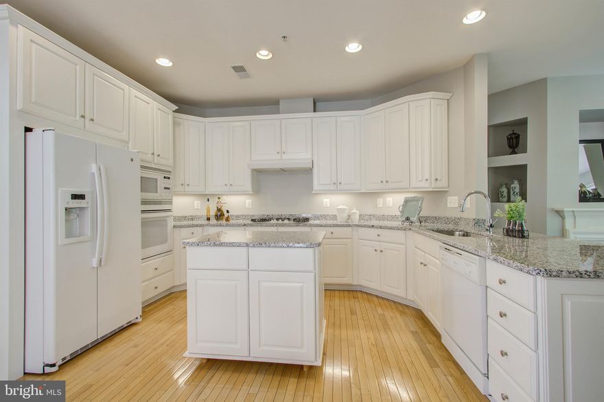 Upgraded Kitchen as of 09/07/2021 - new granite counters & more! Luxury End Unit 2-Car Garage, Brick Front Townhouse on Premium Lot Backing to Trees. Sun light filled home. Includes 4 bedrooms -3 full baths ,plus 1/2 bath . High ceilings - Open floor plan - Band new paint, lights, Newer AC unit - Newer Roof, Gutters, Downspouts, Washer/Dryer and more . 
Guest Suite on Entry Level includes your  4th Bedroom, Full Bathroom, Family Room, Fireplace, and Walkout to Patio Large Office on Main Level w/ Walk Out to Deck with private view . Eat-in Kitchen w/ Breakfast Bar Opens to Family Room w/ Fireplace & Ceiling Fan and Walkout to Deck. Spacious Living & Dining Rooms w/ Crown Molding & Chair Rail. Large Master Suite w/ Tray Ceiling, Ceiling Fan, & Walk-in Closet. Updated  Master Bath w/ Double Sink, Water Closet,  Soaking tub and  updated Shower Stall.
 2 Large Guest Bedrooms & Full Guest Bathroom on Upper Level. Enjoy Your Large Refinished Deck w/ Treed Views in the Summer, Amazing Fall Colors, & River Views in the Winter. Cascades Community Amenities - 5 Pools, 13 Tennis Courts, Clubhouses, Exercise Room, Trails, Playgrounds, & More!