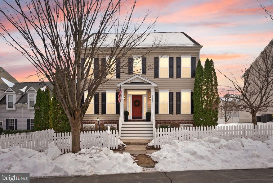 Storybook charm meets modern living in this delightful dollhouse, perfectly framed by a white picket fence in the highly sought-after Belmont Greene community in the Stone Bridge High School pyramid. Inside, a flowing main level showcases hardwood floors, gracious living and dining rooms, and a beautifully renovated gourmet kitchen with timeless finishes. The inviting family room, anchored by a gas fireplace and custom built-ins, opens seamlessly to a stunning tiered patio complete with a pizza oven—ideal for both entertaining and everyday unwinding. The 2-car garage offers convenience for vehicles and storage. A fenced in yard offers privacy and peace of mind.

Upstairs, the sizable primary bedroom is accented by a tray ceiling. A luxuriously renovated bathroom beckons, with stylish linear tile flooring, lovely lighting, a dual vanity, soaking tub and separate shower.  To round it off - a walk in closet. Three additional bedrooms, plus a hall bath finish out this level. 

The lower level adds even more flexibility with a spacious rec room, game area and wet bar, den, full bath, and ample storage. This exits via stairs to the rear yard.

Belmont Greene is an English-inspired neighborhood known for its sweet Colonial architecture and charming town greens, but it is also located very close all the modern conveniences your heart desires! Just minutes from Whole Foods, Wegmans, Trader Joe’s, retail and dining of Ashburn, One Loudoun, historic Leesburg, and Brambleton. With easy access to commuter routes and Dulles International Airport, this is refined living with everyday convenience. Live happy at 20413 Peckham Street.

(All information deemed reliable but not guaranteed, and should be independently verified)