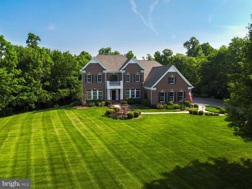 Welcome home to your exceptional, METICULOUSLY-MAINTAINED estate home in sought after Cedar Crest which is nestled on a PRIVATE 3-acre wooded lot with ENCHANTING treed views!  Your STATELY brick front RETREAT has a 3-car garage with a 240V electric vehicle charging station and has an IMPRESSIVE fenced, level backyard encompassed by SERENE trees! The open, airy floor plan boasts UPGRADES GALORE and with all levels finished, it features almost 6,700 total finished square feet! BRING THE ENTERTAINING OUTDOORS to the purposefully designed & professionally installed BACKYARD PARADISE ('17) consisting of an extensive open-air, maintenance-free deck, and LUXURIOUS stone patio with outdoor fire pit area, COZY gas fireplace--no details left untouched! Inviting Foyer with SOARING 2-story ceiling opens to spacious Living & Dining Rooms with GLEAMING hardwoods. Your GOURMET Kitchen is equipped with ample 42" cabinets, GRANITE countertops, commanding center island, Chef's Delight appliances, GLEAMING hardwoods & a HUGE walk-in pantry. The Kitchen, perfect for the inspired home chef, opens to your Breakfast Room, SUN-DRENCHED Sunroom & Family Room which boasts a STRIKING gas fireplace! Your main level PRIVATE Study is quietly tucked away from your home’s lively epicenter! Your Laundry Room, located on the main level, includes a NEWER washer/dryer ('18), built-in cabinets/Corian countertop/sink & tile flooring! Your Owner's Bedroom Retreat boasts a spacious floor plan, SITTING AREA, three-sided fireplace, GIGANTIC walk-in closet & Owner's Luxury Bath! All Upper Level Bedrooms are ENSUITE with its own full bath! Your fully finished WALK-OUT lower level has an EXPANSIVE Recreation Room with CUSTOM built-in shelves and cabinets with accent lighting ('16), Game Room with custom BAR with upgraded cabinetry, Full Bath & PHENOMENAL Media Room ('16) with STADIUM SEATING (seating and media equipment convey)!  Sellers spared no expense - almost $348K in UPGRADES! Updates Include: ROOF w/architectural shingles ('20), HVAC--Upper Zone ('21) & Main Zone ('17) w/cleaned ducts throughout ('21), 75-gallon water heater ('19), 240V plug in garage ('16), aluminum fencing in Backyard ('16), underground sprinkler system, outdoor ACCENT lighting ('19), UPGRADED insulation in attic ('16), PLANTATION SHUTTERS throughout ('16), resealed driveway ('22) & more! Conveniently located minutes to MAJOR commuter arteries, Dulles Airport, shopping, school, medical facilities, restaurants & more!  Make this breathtaking estate home yours!  Be sure to check out the VIDEO & 3D TOURS!