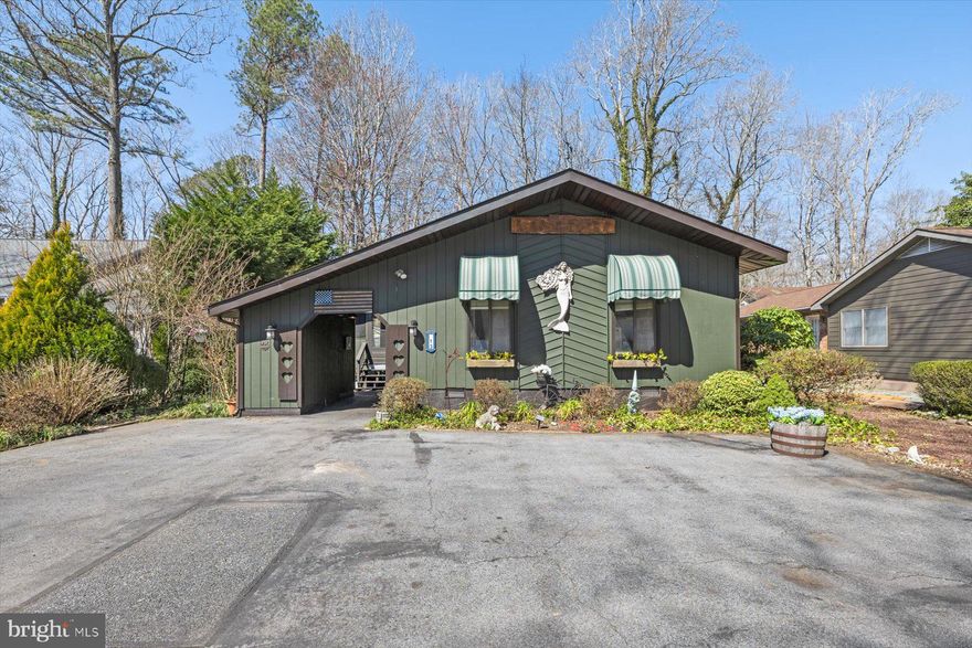 Welcome to this unique and cozy home nestled in the heart of Ocean Pines on one of the community’s finest cul-de-sac streets. From the paved driveway you enter through a breezeway with a built-in shed that offers convenient storage before approaching the spacious screened-in front porch with ceiling fan, a perfect place to relax and enjoy the peaceful setting. Step inside to an open one level main living area that feels warm and inviting. To the left of the entry is the dining area which flows into a bright sunroom surrounded by windows allowing natural light to pour in. The sunroom is carpeted with ceiling fans and provides access to the side deck, creating a wonderful space for indoor and outdoor living. The living room features cathedral ceilings and a cozy wood burning stove that can heat the entire house during the colder months. Luxury vinyl flooring was recently installed throughout the kitchen, dining area, living room and hallway. The kitchen features stainless steel appliances and an efficient layout that opens to the main living spaces. The home offers three spacious bedrooms including a primary bedroom with its own private bathroom suite and a total of two full bathrooms. Step outside to enjoy the large open yard with a fire pit, perfect for gatherings or quiet evenings under the stars. A large storage shed provides additional space for tools and outdoor equipment.  Enjoy the many outdoor living spaces including the porch, deck and patio areas that make this home ideal for entertaining. Plenty of parking is available on the paved driveway 5-6 cars and on street. Tax records do not reflect the additional 1,050 square feet that includes the expanded dining and sunroom area. Roof replaced in 2019 and water heater replaced in 2024.