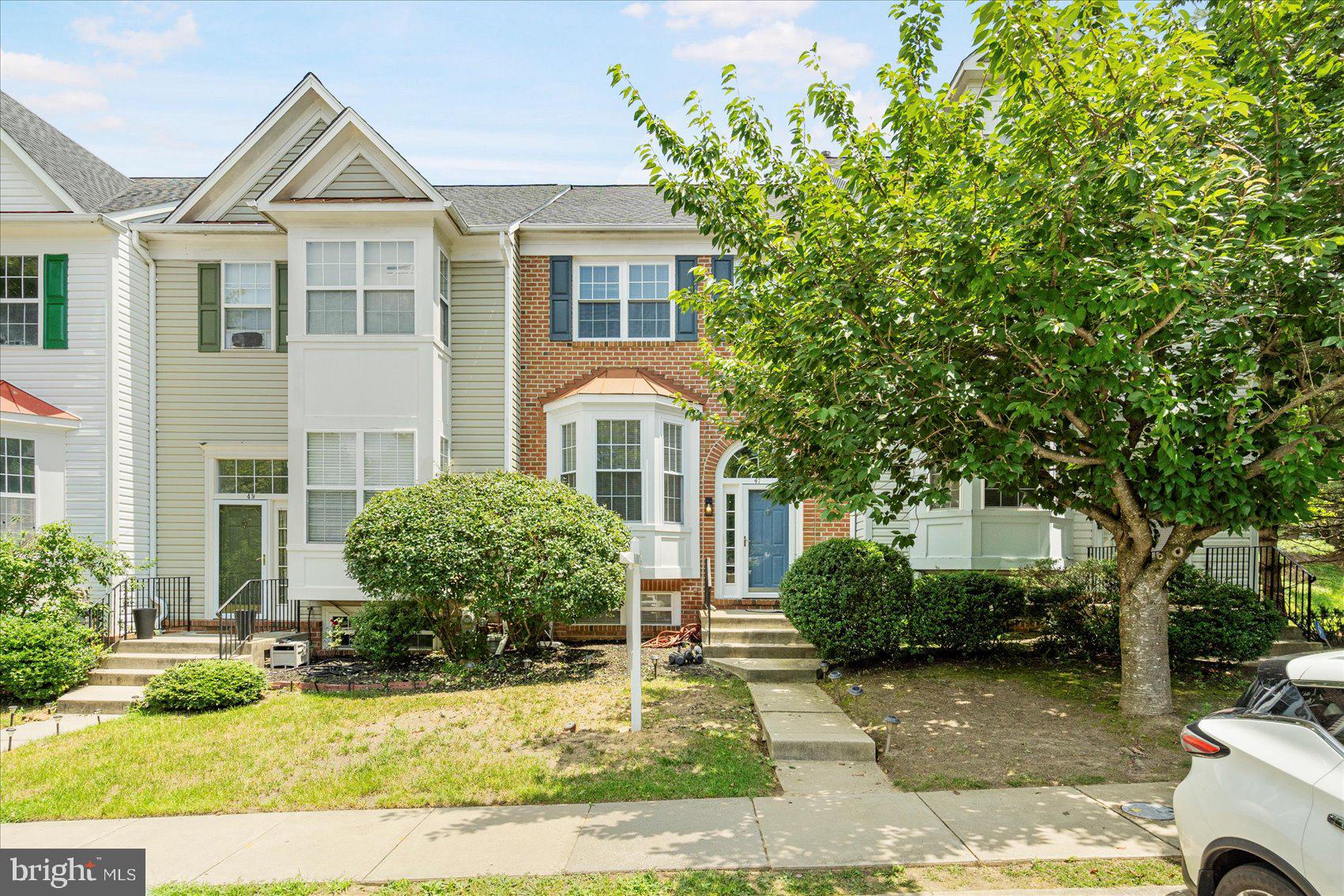 Beautifully maintained and move-in ready 4BR/2.5BA Townhome located in the desirable community of Foxridge. Parking is just steps from the front door into your forever home. Open the door and step inside to a home filled with natural light, gleaming hardwood floors, a soft color palette, and an open floor plan. The main floor features a large living room, dining room, a half bath, and newly updated kitchen. The kitchen boasts plenty of cabinets, stainless steel appliances, quartz countertops with a beautifully tiled backsplash, and a deep stainless sink under a window. On the second floor is a large primary suite with a private full bath and walk-in closet, two sizable secondary bedrooms, a full bath, and all bedrooms feature vaulted ceilings. The lower level is finished offering additional living space to include the fourth bedroom, laundry, storage, and a large family room with sliding doors to a covered patio area and a storage shed. From the dining room, step outside to a large deck that overlooks the surrounding community. This home is ideal for any new homeowner and is located in close proximity to shopping, restaurants, and commuter routes.