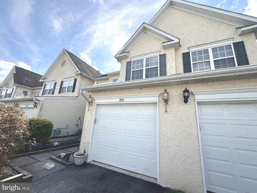 Welcome to 189 Gillespie Avenue in Middletown, DE! This charming A-Frame style townhome boasts 2 bedrooms and 2.1 bathrooms, with a one-car garage. Located in the sought-after Willow Grove Mill Community and within the top-rated Appoquinimink School District, this home is sure to impress. 
As you enter the foyer, you'll be greeted by beautiful wood flooring that leads into the spacious dining and family room area. The open layout is perfect for entertaining or relaxing with loved ones. Pride of ownership shows. You will be amazed at the space you'll find here. Foyer entrance features wood flooring. Stepping into the combo dining/family room area. These two areas are divided by beautiful half wall columns gracefully separating these two rooms. You have so many options for these combo rooms. Flowing right into the kitchen with wood floors, stainless steel appliances flowing into the added extension that is open for you to design it with your special touches. Plenty of light from the triple window covered with custom blinds. Open the sliding glass doors flowing out onto the custom paver patio with a section of vinyl privacy fencing and the backyard complete with vinyl split rail fencing. Great yard for entertaining family and friends and gathering around the custom paver firepit. This home offers both accessibility and comfort. Heading to the upstairs is where you find the half bathroom conveniently located to the family room area. Up the stairway you go to find this cozy extra sitting area. This area flowing into the second nice sized bedroom. Featuring its own private full bathroom with tub/shower and a walk-out private balcony. Back out to the hallway leading to the primary bedroom on your right you'll find the convenience to each bedroom your laundry room. Continue on to the Primary Bedroom, which is very generously spacious Featuring the generous sized custom walk-in closet and an en-suite bathroom with dual vanities, a jetted tub, a walk-in shower, with a separate water closet. Flowing from the bedroom you'll find the extension space for you to use it as a nursery, office, cozy reading spot, designated TV room.   So many uses for this room, make it your own. Faux window blinds included where present. Don't miss out on this fantastic opportunity to own a beautiful townhome in a prime location. Conveniently situated just off Rt 1 and minutes from downtown Middletown. Easy access to Route 1 connecting to I-95 & 495 with direct access to Philadelphia Airport. For the beach goers, convenient to all Delaware beaches and Ocean City, Md. Don't miss out on this one. Schedule your showing today!