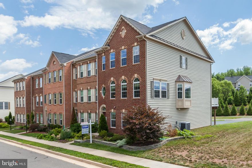 Need some elbow room? Beautiful spacious end unit townhouse faces woods, hardwoods on the main living area, gourmet granite kitchen with island and double ovens, sprawling master suite, closet built-ins Bright, pretty windows. Stacked stone retaining wall, nicely landscaped, lots of open space! Community pool. Plenty of parking- 8 car driveway and 2 car garage!