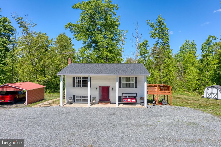 Country Living at Its Best – Privacy, Acreage & Endless Potential

Tucked away on the edge of the woods, this private retreat sits on a beautiful 12.50-acre lot, offering the perfect blend of peaceful country living and everyday convenience—just a short drive to historic downtown Culpeper.

Surrounded by nature and abundant wildlife, this property is ideal for those seeking space, freedom, and versatility.

Inside, you’ll find a bright and open floor plan with beautiful hardwood floors throughout the main level. The spacious living room flows seamlessly into the dining area and country kitchen, complete with stainless steel appliances, a large island, and ample cabinet and counter space—perfect for gathering and entertaining. Natural light fills the home, creating a warm and inviting atmosphere.

The primary suite offers a relaxing retreat with a walk-in closet and private full bath, along with direct access to a deck—perfect for morning coffee or quiet evenings overlooking the property.

The lower level features a large family room with a cozy woodstove, an additional bedroom and full bath, plus a spacious laundry room with plenty of storage. Walk-out access adds convenience and functionality.
Step outside and enjoy everything this property has to offer:
A welcoming front porch made for relaxing, sidewalks surrounding the home, a detached garage, two-car carport, and multiple storage sheds for all your equipment and hobbies.

With no restrictions, this property is ideal for animals, horses, ATV riding, or hunting, with multiple prime spots throughout the land. Whether you’re looking for a private homestead, recreational retreat, or future investment, the possibilities here are endless—including potential for lot division (buyer to verify with zoning).

A rare opportunity to own your own slice of the countryside—private, peaceful, and full of potential.