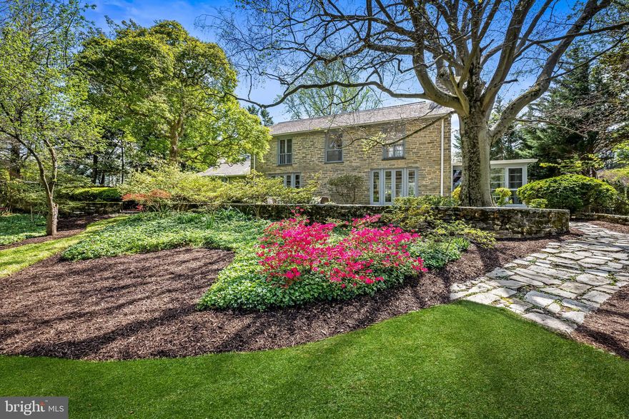 Searching for the perfect multigenerational floor plan with an abundance of space for retreat or large-scale gathering in a beautiful private setting? Visit this stunning contemporary stone retreat on over an acre with lush landscaping offering sanctuary for those seeking refinement and accessibility in one of Baltimore County’s most beautiful and convenient neighborhoods. The current owner is relocating out of state, presenting a rare opportunity for purchasers. Last spring, this exceptional residence was purchased after only three days on the market, highlighting its widespread popularity. Seller has performed numerous updates and improvements. Built in the mid-20th century, design elements include exterior stone walls, maple flooring with cherry and mahogany inlay, clean lines, open flow, flexible spaces, and gallery walls for collections. Skylights and large walls of windows offer natural light and garden views from almost every room. The main floor offers one-level living opening to three unique outdoor living areas. Enter the spacious great room currently serving as a formal sitting room with gas fireplace adjacent to the dining area with views to gardens and just steps to the handsome gourmet kitchen with large island and breakfast bar, quartzite counters, a Subzero 48” Pro fridge/freezer, a Wolfe dual-fuel gas range, wall and steam ovens, a Décor warming drawer, a Subzero wine tower cooler, and two sinks and dishwashers. A bay window surrounds the breakfast room, and nearby French doors open to the side terrace for kitchen gardening and barbecues, and easy access to the level lawn. A large family room with a wood-burning fireplace is adjacent to a sunroom with custom built-in cabinetry and a wet bar. The owner's wing features the primary bath and bedroom with fireplace and French doors to deck, and a study that opens to rear terrace. A separate two-bedroom guest wing with full bath and separate entry offers opportunity for in-laws, or an au pair. The upper-level features two generously sized bedrooms, a full bathroom, and large cedar-lined storage room. The bluestone rear terrace, with sitting walls, stretches under a towering American beech tree, offering ample space for large gatherings. Walk through the boxwood allée and perennial garden paths to reach the heated pool with retractable cover and access a pool house equipped with party kitchen, full bath with room for group workouts, or remote workspace. Walk through Woodbrook to Lake Roland, a 500-acre nature preserve with trails, a dog park, and a nature center, or visit the charming village across Charles Street for a boutique grocery and morning coffee. With its myriad of amenities and thoughtful design, this property offers a lifestyle where location, comfort, and quality enrich everyday living. Minutes from schools, I-695, and Baltimore's vibrant Inner Harbor.