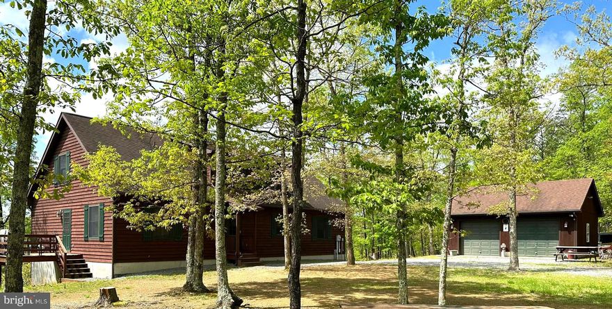 This expansive CUSTOM BUILT, CEDAR SIDED residence in New Creek, West Virginia, offers a harmonious blend of rustic charm and modern comfort and MAJESTIC VIEWS. The two-story home boasts 2 bedrooms, 3 bathrooms, and a loft, providing ample space for both living and entertaining with 23 unrestricted acres to roam.

Upon entering, you're greeted by a stunning great room with soaring vaulted ceilings adorned with warm wood. The space features a cozy wood-burning stove set against a striking floor-to-ceiling stone chimney, creating a focal point that exudes warmth and character. Large windows flood the area with natural light, offering picturesque views of the surrounding landscape.

The open-concept layout seamlessly integrates the living, dining, and kitchen areas. The kitchen is a chef's dream, equipped with modern appliances, ample cabinetry, and a spacious island, perfect for casual dining or food preparation. Granite countertops and a tile backsplash add a touch of elegance to the space.

A wooden staircase leads to the second floor, where you'll find a loft overlooking the great room, adding to the home's airy feel. 

The primary bedroom offers a tranquil retreat with  multiple windows for natural light and primary bath soaking tub.

The bathrooms are thoughtfully designed adding a whimsical touch to the rustic ambiance. The home also includes a dedicated laundry room with modern appliances and built-in storage.

Throughout the house, hardwood floors, exposed wooden beams, wood railings, and a neutral color palette create a cohesive and inviting atmosphere. 

Full unfinished basement waiting for the addition of extra rooms.  OUTDOOR SHOWER can be found just steps outside the large basement doors.  2 Car detached garage, RV Storage Shed & Storage Shed for all your outside storage needs.

This residence at 361 Clarks View combines the coziness of a mountain retreat with the conveniences of modern living, making it an ideal home for those seeking a balance of comfort and rustic charm in the heart of West Virginia.

An additional 29 acs can be purchased separately with a contract on this property.