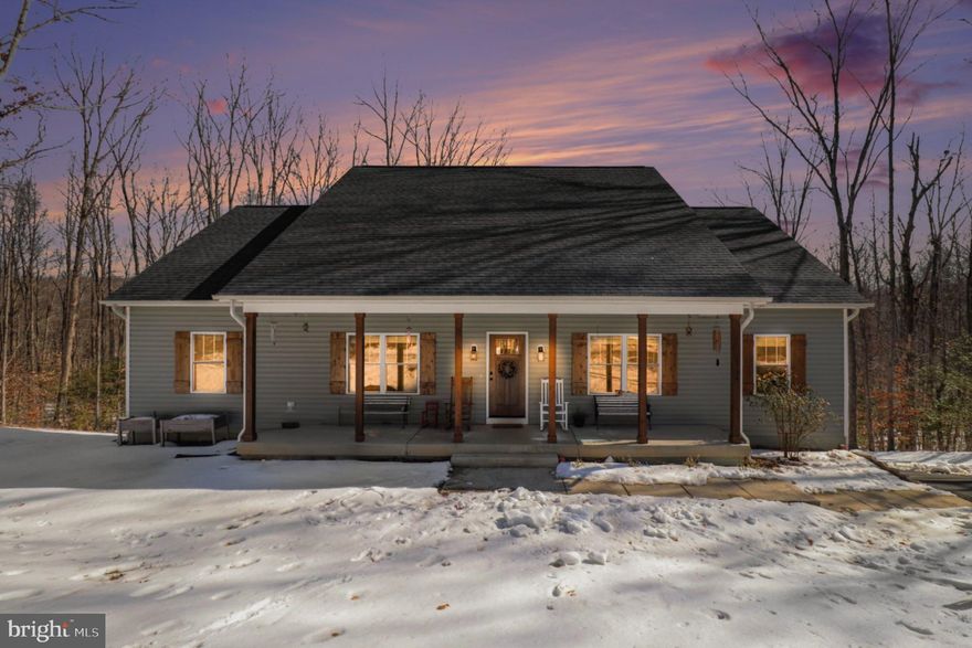 This stunning 2023 built ranch-style home offers a perfect blend of modern design and rural tranquility. Spanning almost 2,000 fin. sqft of main level living this open floor plan features luxury vinyl plank flooring and recessed lighting throughout. The gourmet kitchen boasts stainless steel appliances, granite countertops, island and an eat-in area ideal for gatherings. Split bedroom design with four spacious bedrooms. Primary bedroom with walk-in closet, primary bath with dual sink, granite countertop &  walk-in shower.  Set on a generous 4-acre lot that backs to serene trees, this property provides ample outdoor space for relaxation and recreation. Enjoy the outdoors from the full front porch or expansive covered rear deck. The improved  basement wont take much to finish with studding and  sheetrock completed along with a fully finished bathroom.  The massive detached oversized garage and asphalt driveway provides plenty of space for parking and storing the toys. Located in a peaceful rural setting, this home combines craftsmanship and comfort, making it a perfect retreat. Experience the unique architectural features and exceptional quality of this remarkable property.