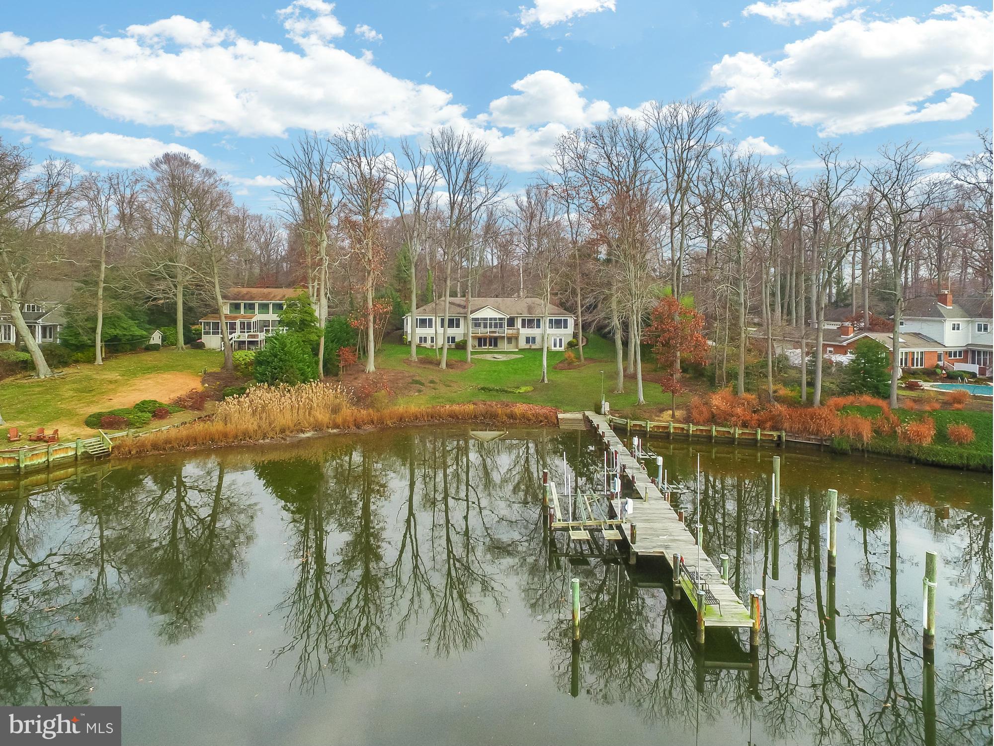 Waterfront home with big waterviews & 185 ft on protected Ridout Creek, private pier & waterfront screened porch. Open floor plan includes 2 main level Master BR suites each w/den & FP. Granite counters & SS appliances in kitchen which overlooks Great Rm w/ woodflrs & Rumford FP. Walk out Lower level w/Rec Rm, 2 BRs & ample storage including boat room w/ exterior entrance. Bonus: 4 car garage.