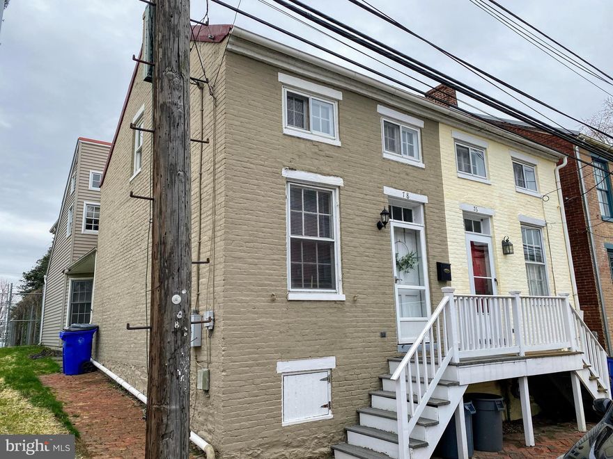 Very nice twin/semi-detached townhouse.   Living  room features a gas fireplace and hardwood floors.  Kitchen is eat in with a side door to yard. and half bath.  Large family room with access to  the fenced in backyard.  Two parking spaces in the back.  Upstairs has a large master bedroom with a walk in closet and small balcony.  Second bedroom in the front of house.  Large bathroom and washer and dryer.  There's enough space in the hallway to have a small office.  Great downtown location...walk to train/bus station and all restaurants and shops!