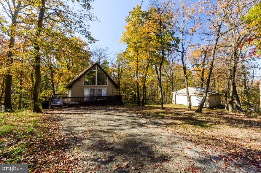 Come home to your own cabin in the woods. This cozy A-frame has so much to offer.  From the 2 car detached garage for all the big boy and  girl toys to the 1 acre of land (partially fenced) you won't be disappointed. This cute home offers lots of light and soaring ceilings. The bright kitchen is ready for you to cook up a nice warm meal this winter. You will enjoy spending time cozied up to the fireplace when the evenings are cool and the nights are long. Also on this level you will find a bedroom and full bath. The upper level offers another bedroom. The lower level finished basement has a recreation room complete with pool/air hockey table, wet bar and full bath. This level also has an additional room that could be used for a 3rd bedroom, den, or office. There is ample decking for entertaining and plenty of off street parking.