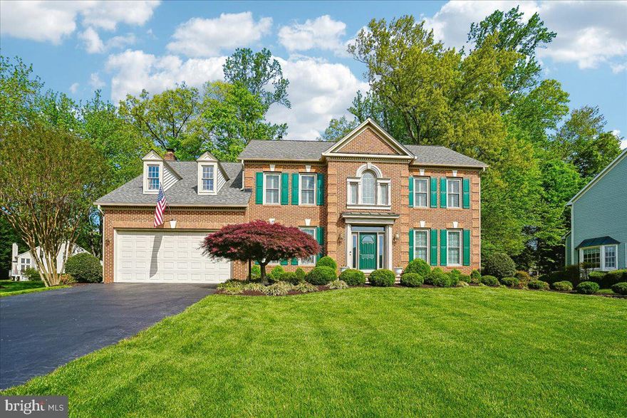 ABSOLUTELY STUNNING! THIS METICULOUSLY MAINTAINED BRICK FRONT COLONIAL IS PERFECTLY SITUATED ON AN EXPANSIVE LOT WITH THE ADDED BENEFIT OF AN ADJOINING OUTLOT, CREATING A WONDERFUL SENSE OF SPACE AND SETTING THAT IS HARD TO FIND.  FOLLOW THE BRICK-LINED FLAGSTONE WALKWAY TO THE FRONT DOOR AND STEP INSIDE THE DRAMATIC TWO-STORY FOYER FEATURING BEAUTIFUL HARDWOOD FLOORS. THE HARDWOODS CONTINUE INTO THE ELEGANT FORMAL LIVING ROOM WITH CROWN MOLDING AND FLOW SEAMLESSLY INTO THE FORMAL DINING ROOM, WHERE CHAIR RAILING AND DECORATIVE PILLARS CREATE THE PERFECT SPACE FOR HOLIDAY GATHERINGS AND SPECIAL OCCASIONS.  AT THE HEART OF THE HOME, THE SUNLIT KITCHEN IS SURE TO IMPRESS ANY HOME CHEF. FEATURING CRISP WHITE CABINETRY, A CUSTOM TILE BACKSPLASH, GRANITE COUNTERTOPS, STAINLESS STEEL APPLIANCES, AND A CENTER ISLAND WITH PENDANT LIGHTING, THIS SPACE IS AS FUNCTIONAL AS IT IS BEAUTIFUL. THE ISLAND PROVIDES THE PERFECT SPOT FOR SERVING, FOOD PREP, OR CASUAL SEATING WITH BAR STOOLS. ADDITIONAL FEATURES INCLUDE A DESK AREA, A SEPARATE BEVERAGE CENTER WITH REFRIGERATOR, AND A BREAKFAST ROOM WITH A VAULTED CEILING AND A WALL OF WINDOWS OVERLOOKING THE MATURE TREES AND REAR YARD.  AFTER ENJOYING A MEAL, STEP DOWN INTO THE INVITING FAMILY ROOM WHERE YOU CAN WATCH THE BIG GAME OR UNWIND BY THE BRICK SURROUND WOOD-BURNING FIREPLACE WITH MANTEL ON A CHILLY EVENING. FROM HERE, STEP OUT TO THE CUSTOM SCREENED-IN PORCH WITH TREX FLOORING—THE PERFECT PLACE TO DINE AL FRESCO OR SIMPLY ENJOY THE SURROUNDING NATURE. TWO DOORS PROVIDE ACCESS TO THE BEAUTIFULLY LANDSCAPED YARD COMPLETE WITH HARDSCAPING, MATURE PLANTINGS, A 9 ZONE IRRIGATION SYSTEM WITH INTERNET BASED CONTROLLER AND A SHED FOR ADDITIONAL STORAGE.  BACK INSIDE, THE MAIN LEVEL ALSO FEATURES A CONVENIENT LAUNDRY ROOM WITH A SIDE-BY-SIDE WASHER AND DRYER, ALONG WITH ACCESS TO THE TWO-CAR GARAGE FEATURING NEWLY PAINTED EPOXY FLOORS. FOR THOSE WHO WORK FROM HOME OR NEED FLEX SPACE, THE MAIN LEVEL DEN WITH CROWN MOLDING PROVIDES THE PERFECT PRIVATE OFFICE OR MUSIC ROOM.  UPSTAIRS, HARDWOOD FLOORS LEAD YOU THROUGH DOUBLE DOORS INTO THE EXPANSIVE PRIMARY SUITE. THIS PRIVATE RETREAT FEATURES A SEPARATE SITTING AREA ACCENTED BY DECORATIVE PILLARS, A VAULTED CEILING, AND A WALK-IN CLOSET. THE RENOVATED PRIMARY BATH OFFERS TILE FLOORS, A DUAL SINK VANITY WITH QUARTZ COUNTERTOP, A SOAKING TUB, AND A STAND-ALONE SHOWER WITH CUSTOM TILE AND A CORNER BENCH.  THE UPPER LEVEL ALSO FEATURES  ONE ADDITIONAL BEDROOM WITH HARDWOOD FLOORS AND A FULL BATH AS WELL AS  TWO BEDROOMS WITH NEUTRAL CARPETING, AND A SHARED FULL BATH DESIGNED WITH TWO SEPARATE SPACES INCLUDING TILE FLOORS, A DUAL SINK VANITY AREA, AND A TUB/SHOWER COMBINATION WITH GLASS DOOR.  THE FINISHED LOWER LEVEL REC ROOM PROVIDES THE PERFECT SPACE FOR RELAXING, EXERCISING, OR ENTERTAINING, WHILE THE HUGE UNFINISHED AREA OFFERS INCREDIBLE STORAGE, A WORKSHOP AREA, OR THE OPPORTUNITY TO CREATE ADDITIONAL LIVING SPACE TO SUIT YOUR NEEDS.  THIS HOME OFFERS THE PERFECT COMBINATION OF ELEGANCE, FUNCTIONALITY, AND OUTDOOR BEAUTY, TRULY A SPECIAL OPPORTUNITY.
