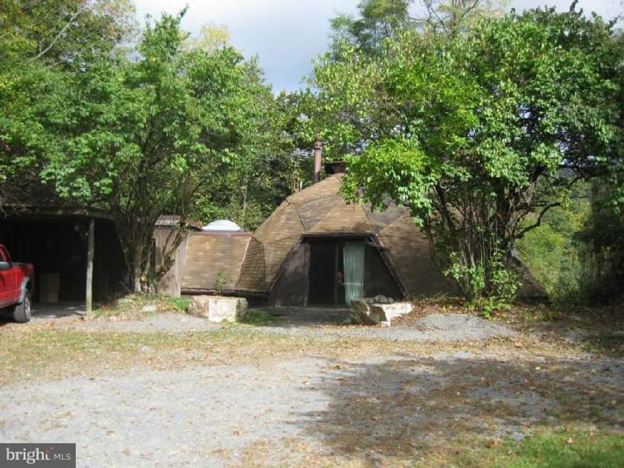 Secluded dome home,  a nature lover's paradise.  Attached work shop, car port and there are also two storage sheds.  Pristine setting on 14+ acres  of woods, stream and lawns.  Update current home as a perfect retreat or build your dream home.  Small pond and lots of magical trails.  Home is being sold "AS IS".